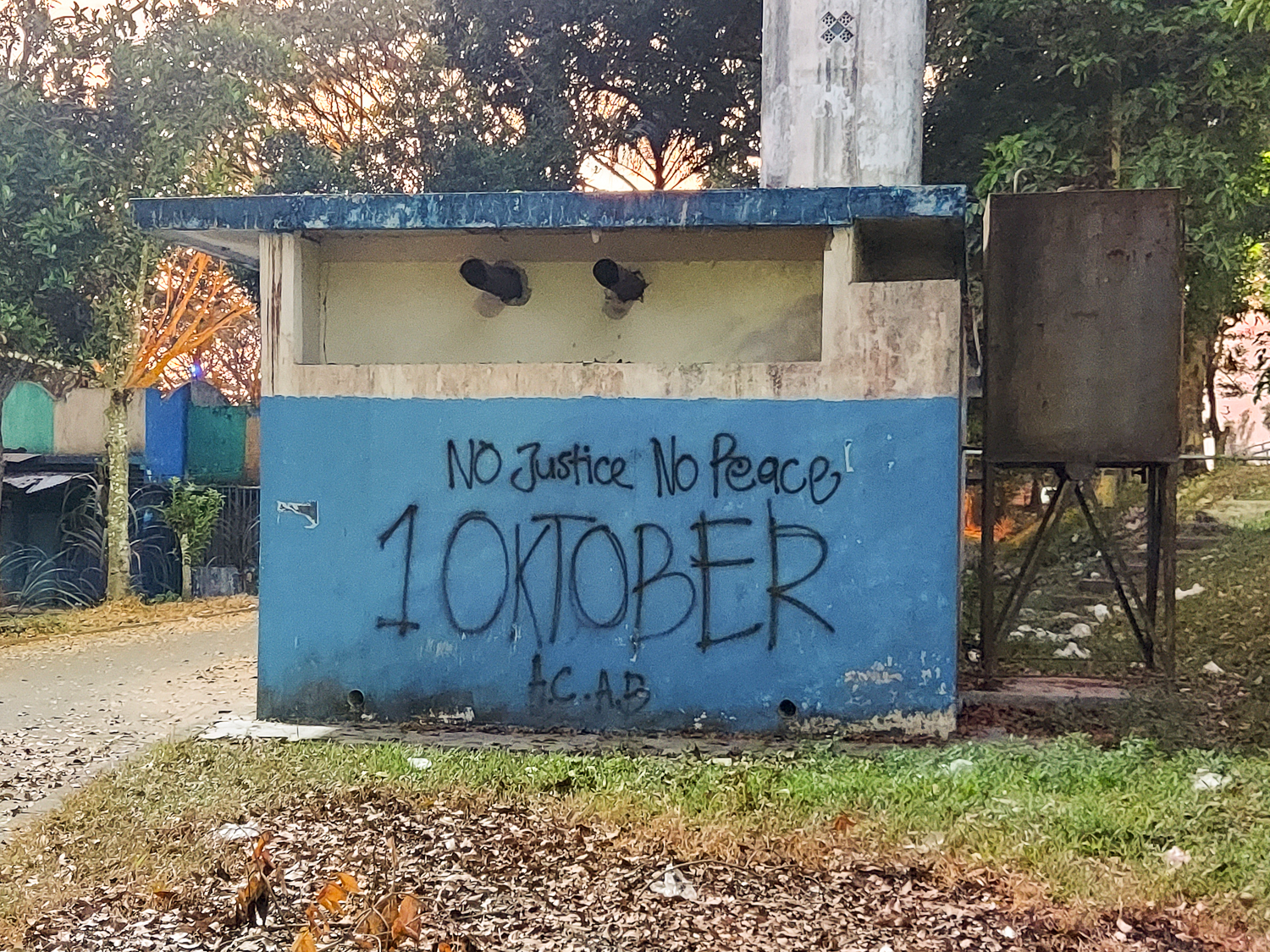 Graffiti scrawled on buildings at the stadium express a lack of justice following the tragedy. 