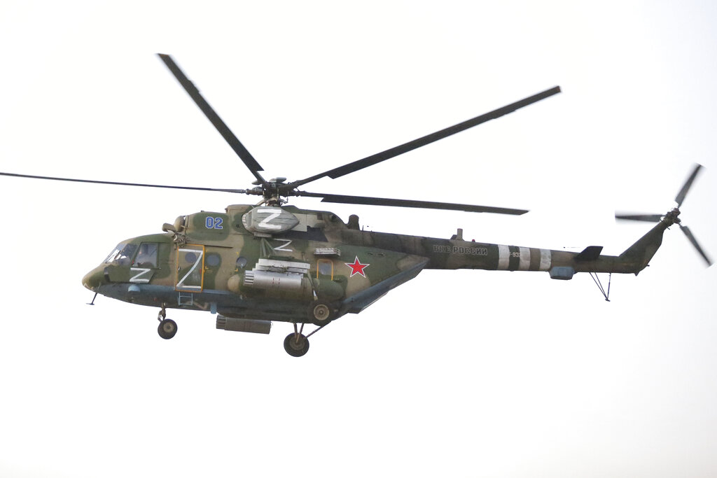 A Russian military Mi-8 helicopter flies over Saur-Mogila memorial, about 60 km. (31 miles) east of Donetsk, separatist Donetsk People's Republic, eastern Ukraine, Thursday, Sept. 8, 2022. (AP Photo/Alexei Alexandrov)