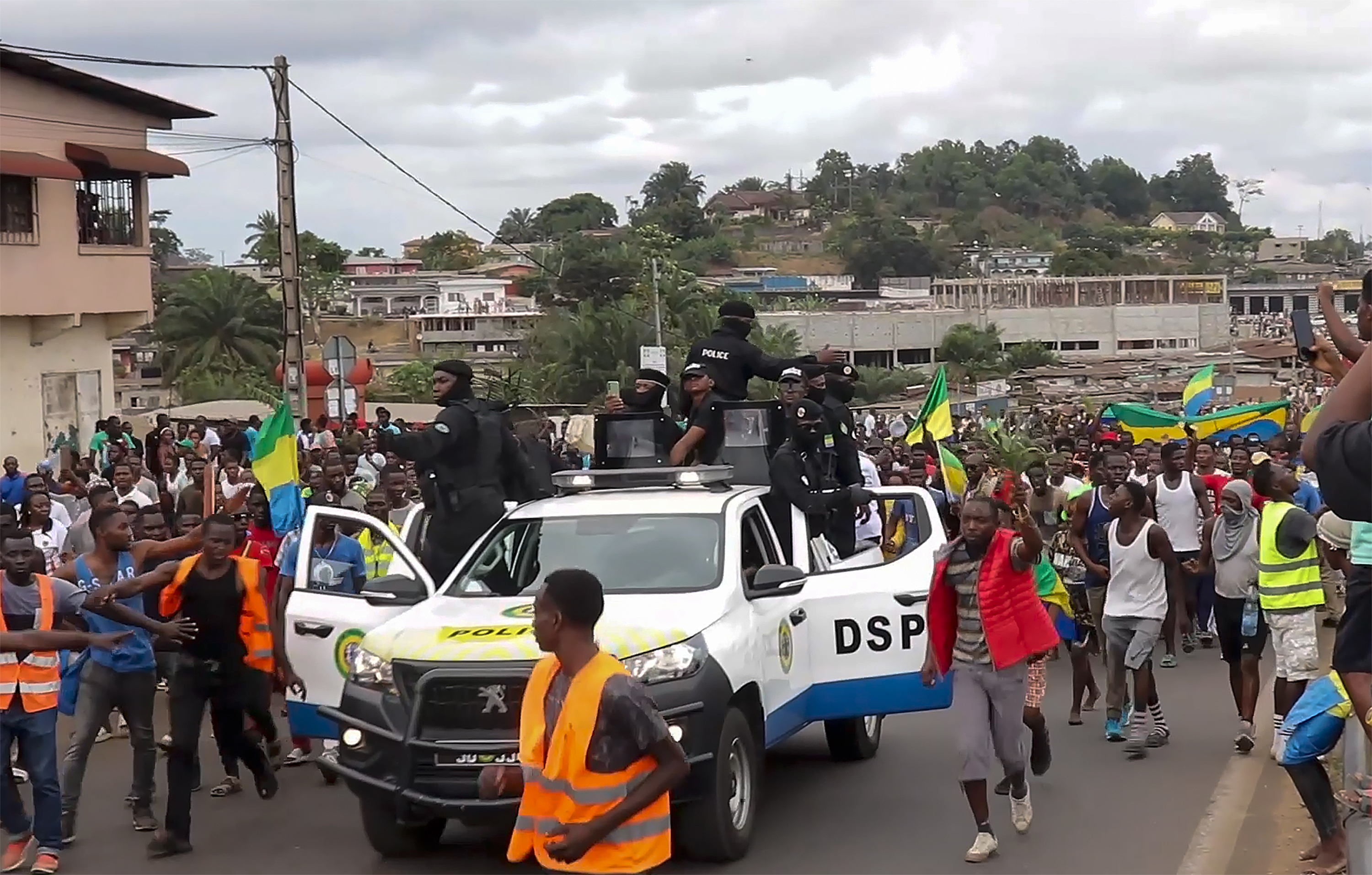 FILE - This video grab shows coup supporters cheering police officers in Libreville, Gabon, on Aug. 30, 2023. Gabon’s opposition leader accused the family of the recently ousted president of engineering his removal from power in order to retain their control in the oil-rich Central African nation. (AP Photo/Betiness Mackosso, File)