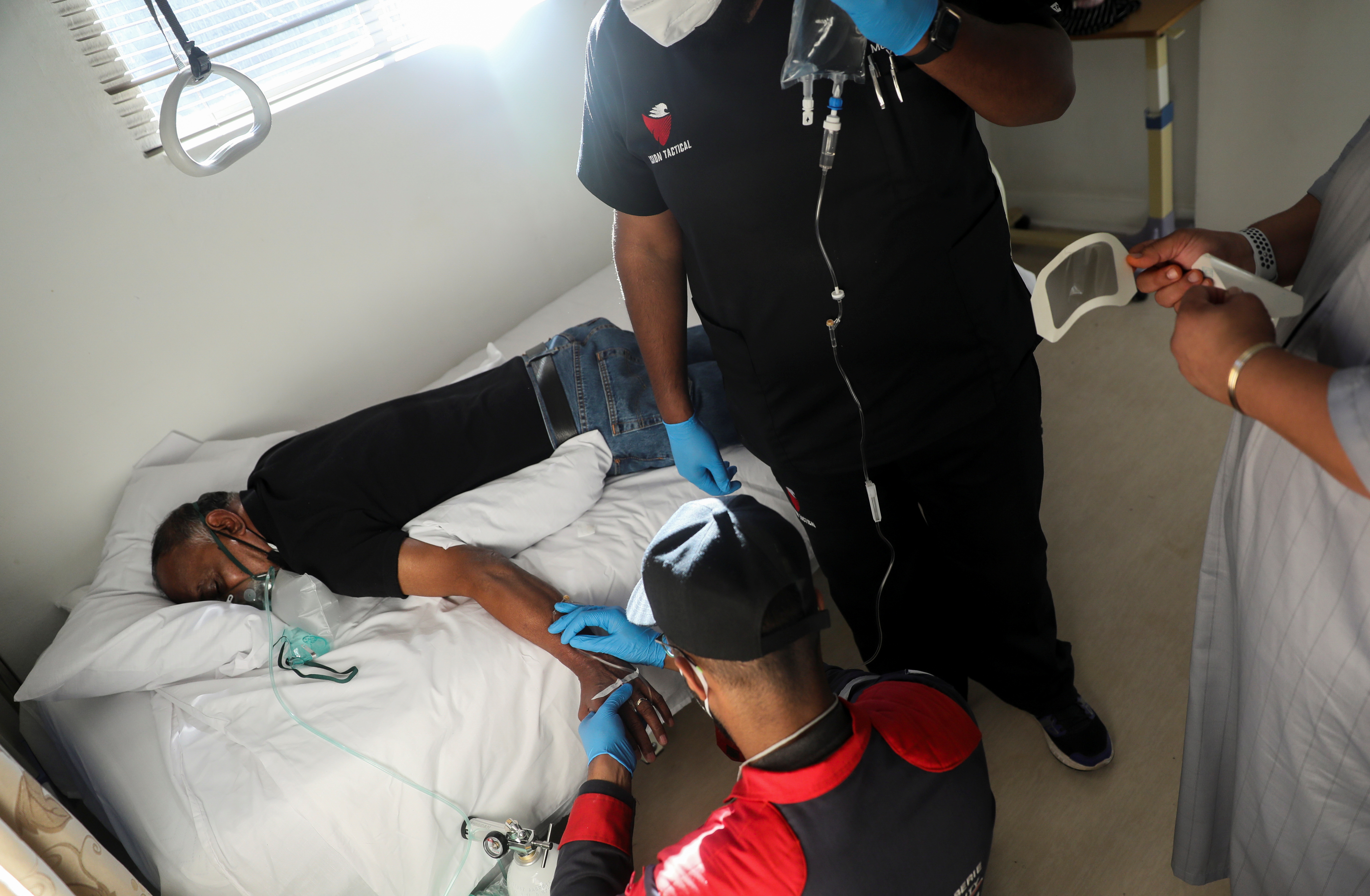 Paramedics attend to a patient during the COVID-19 outbreak in Johannesburg