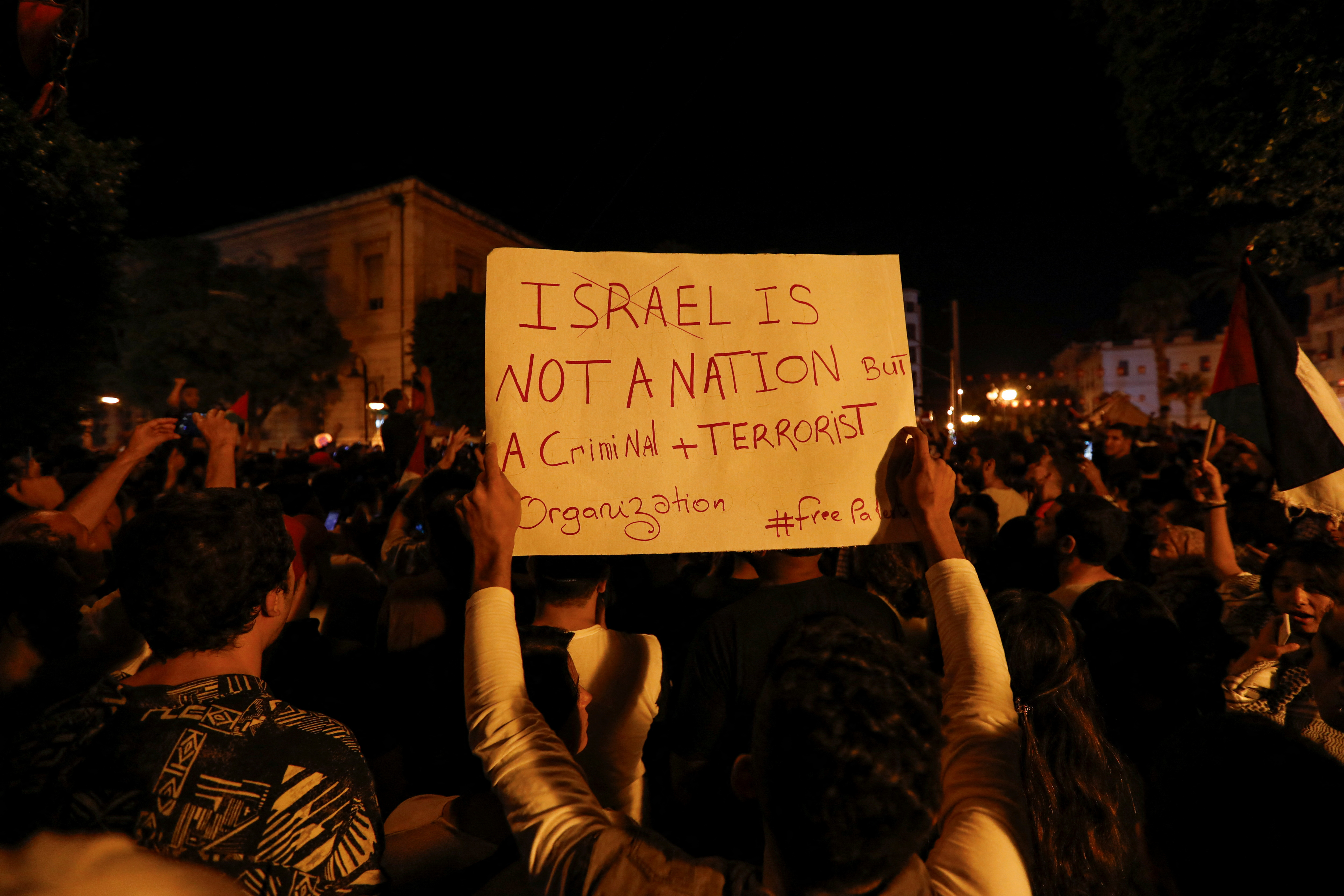 People gather during a protest after hundreds of Palestinians were killed in a blast at Al-Ahli hospital in Gaza