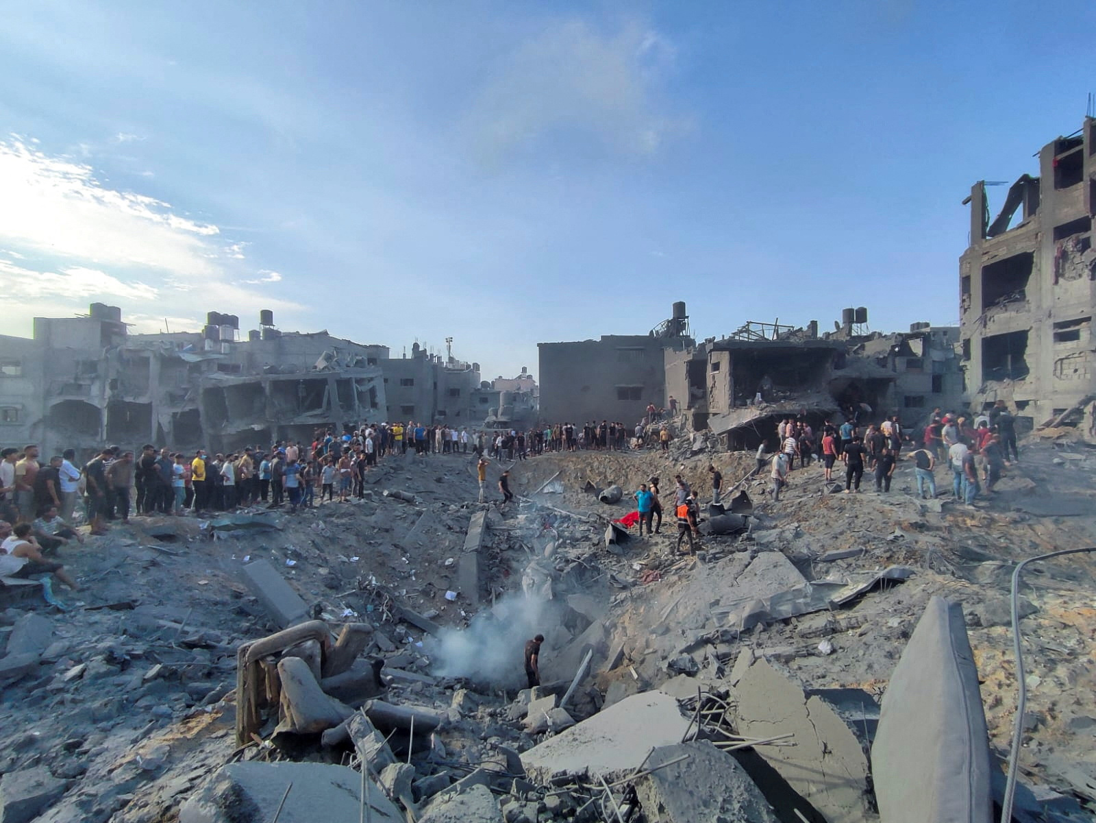 Palestinians search for casualties at the site of Israeli strikes on houses in Jabalia refugee camp in the northern Gaza Strip