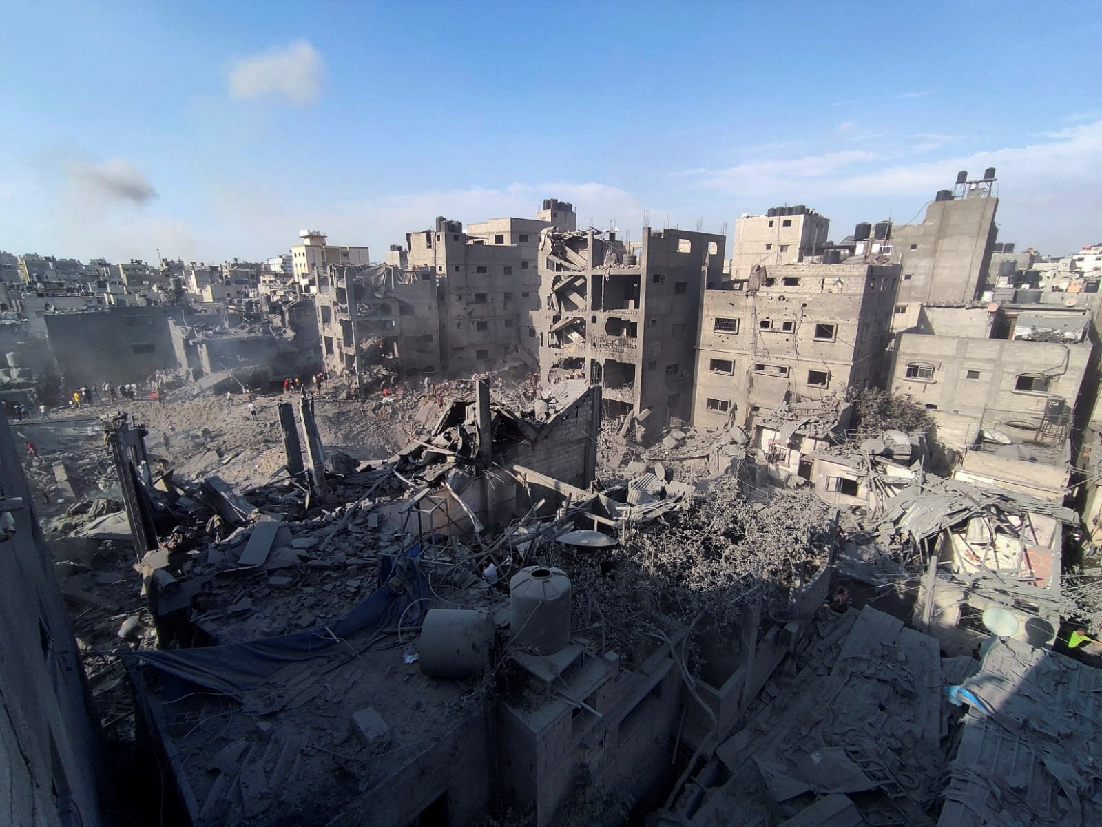 Palestinians search for casualties at the site of Israeli strikes on houses in Jabalia refugee camp in the northern Gaza Strip