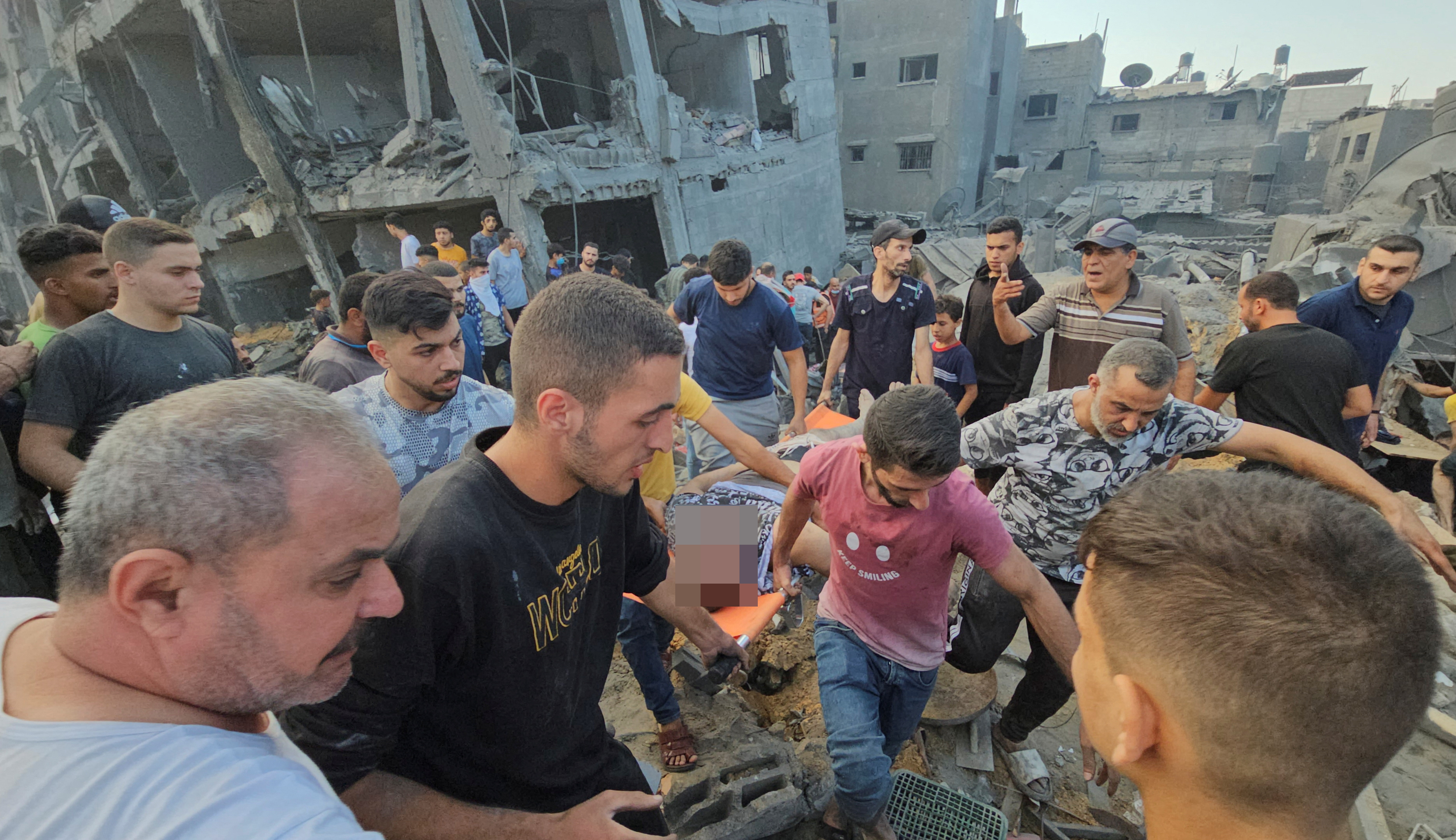 Palestinians evacuate a casualty at the site of Israeli strikes on houses in Jabalia refugee camp in the northern Gaza Strip