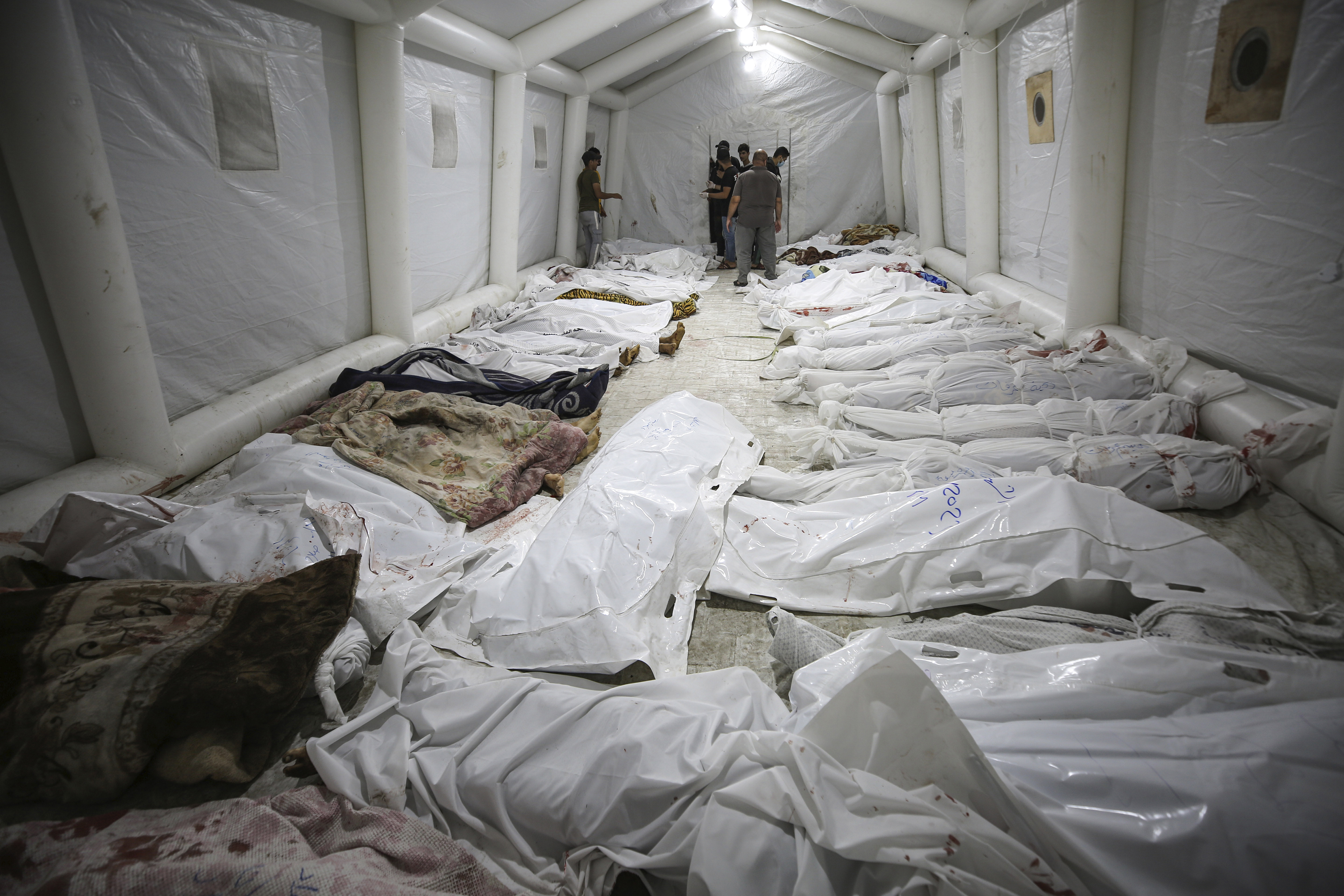 Bodies of Palestinians killed by an explosion at the Ahli Arab hospital