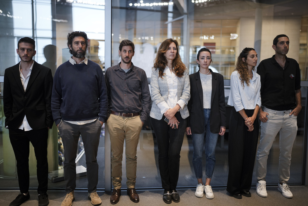 Ricarda Louk and Adi Louk, fourth and fifth from right, stand with other relatives of people taken captive by the Palestinian armed group Hamas in Berlin, Germany