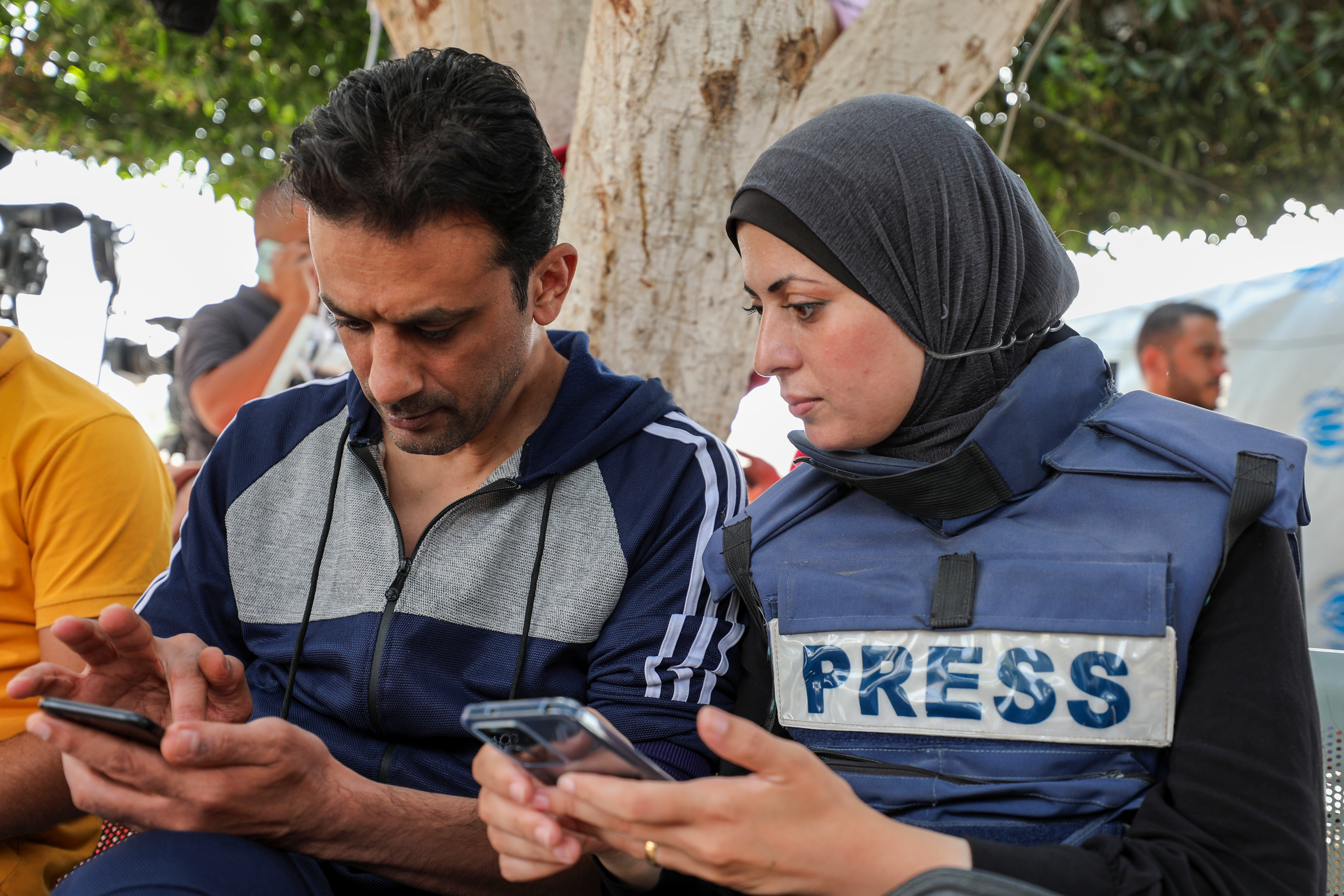 Between live reports from the grounds of Al-Aqsa Martyrs Hospital, Khawla and Baher check for news updates on their phones and try to call their children