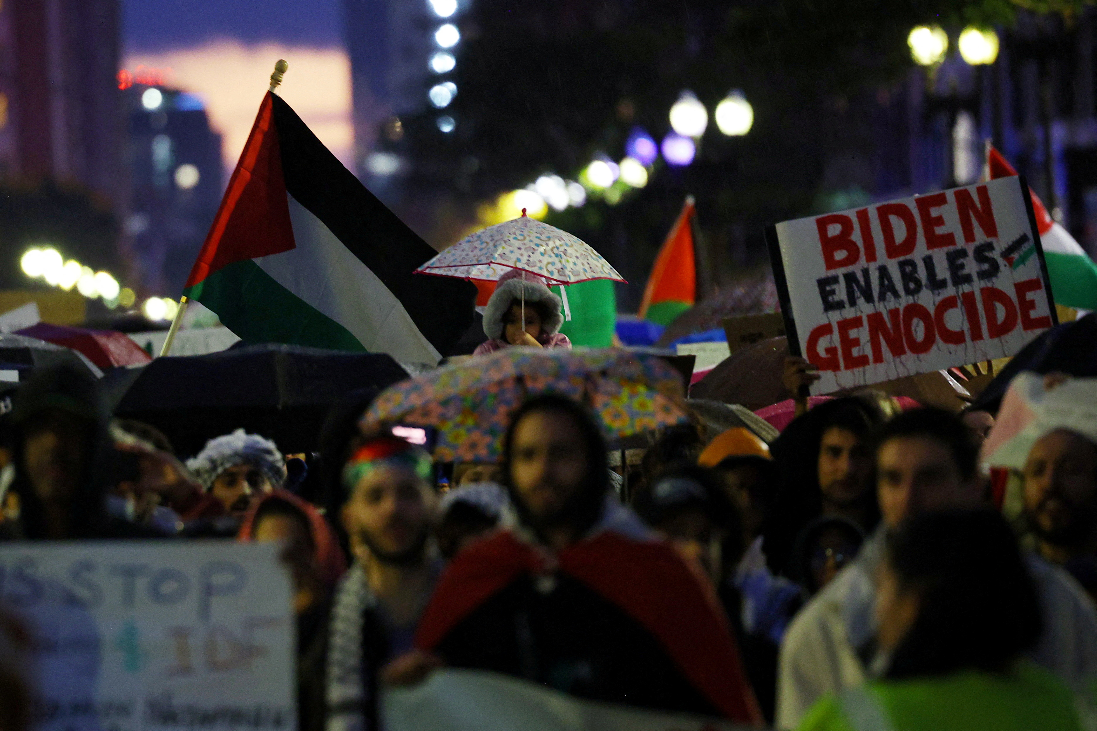 A protest sign reads: Biden enables genocide