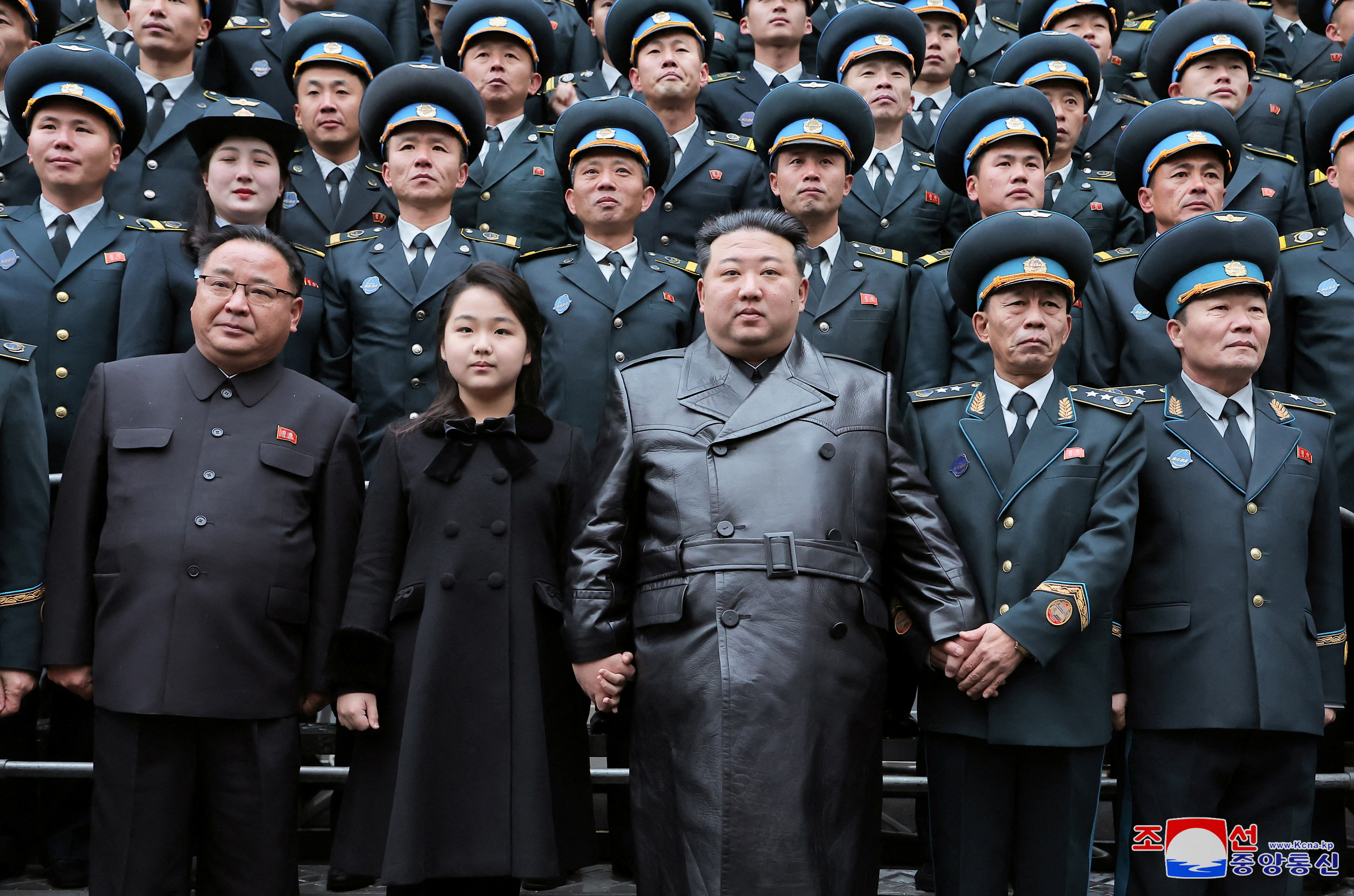 Kim Jong Un with scientists and engineers who contributed to Tuesday's spy satellite launch. He is standing in the front with his daughter next to him.