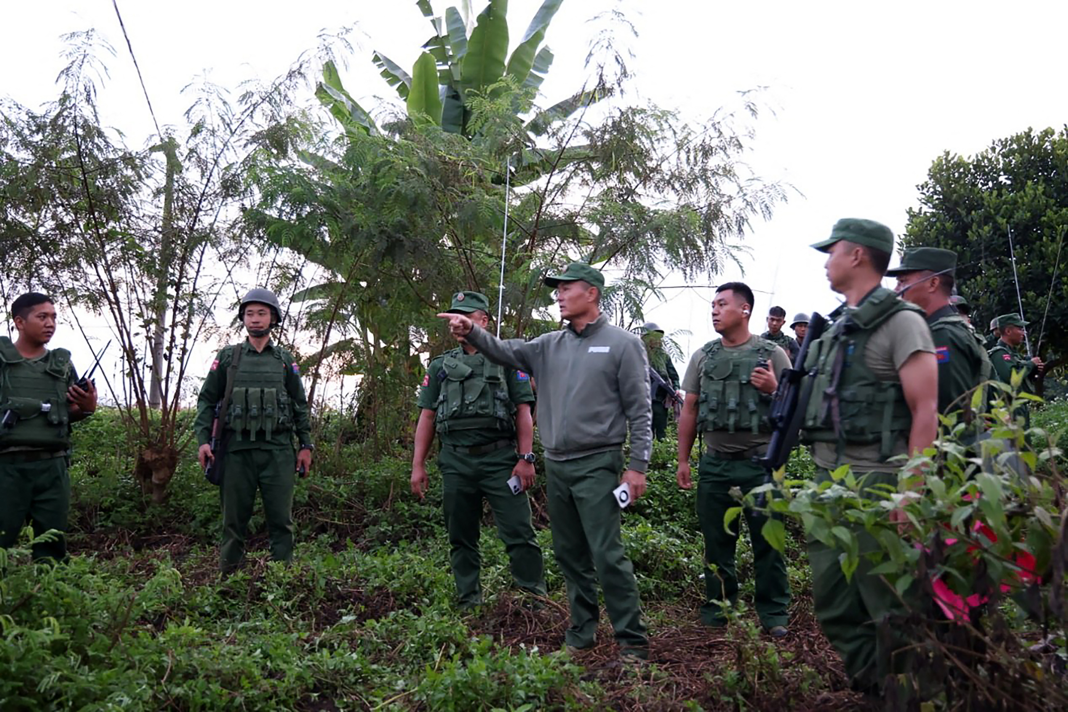 This handout photo taken and released on October 27, 2023 by the Kokang Information Network shows Myanmar National Democratic Alliance Army (MNDAA) Major General Peng Deqi (centre R) commanding operations against Myanmar's military near Lashio township in Myanmars northern Shan State. (Photo by Handout / Kokang Information Network / AFP) / -----EDITORS NOTE --- RESTRICTED TO EDITORIAL USE - MANDATORY CREDIT "AFP PHOTO / KOKANG INFORMATION NETWORK " - NO MARKETING - NO ADVERTISING CAMPAIGNS - DISTRIBUTED AS A SERVICE TO CLIENTS - -----EDITORS NOTE --- RESTRICTED TO EDITORIAL USE - MANDATORY CREDIT "AFP PHOTO / Kokang Information Network " - NO MARKETING - NO ADVERTISING CAMPAIGNS - DISTRIBUTED AS A SERVICE TO CLIENTS /