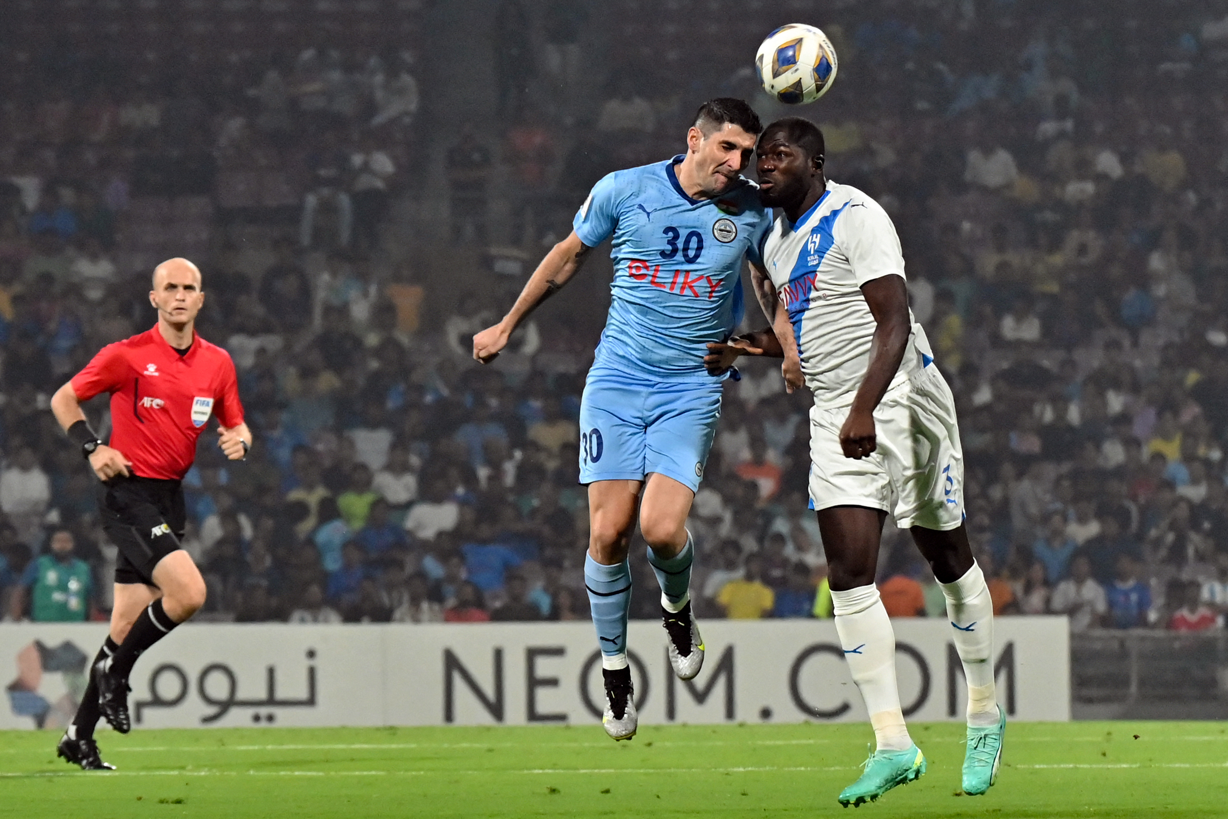 Al-Hilal SFC's defender Kalidou Koulibaly (R) and Mumbai City FC's forward Jorge Pereyra Diaz (C) vie for the ball during the AFC Champions League 2023/24 Group D football match between India's Mumbai City FC and Saudi Arabias Al-Hilal SFC at the D.Y. Patil stadium in Navi Mumbai on November 6, 2023. (Photo by AFP)
