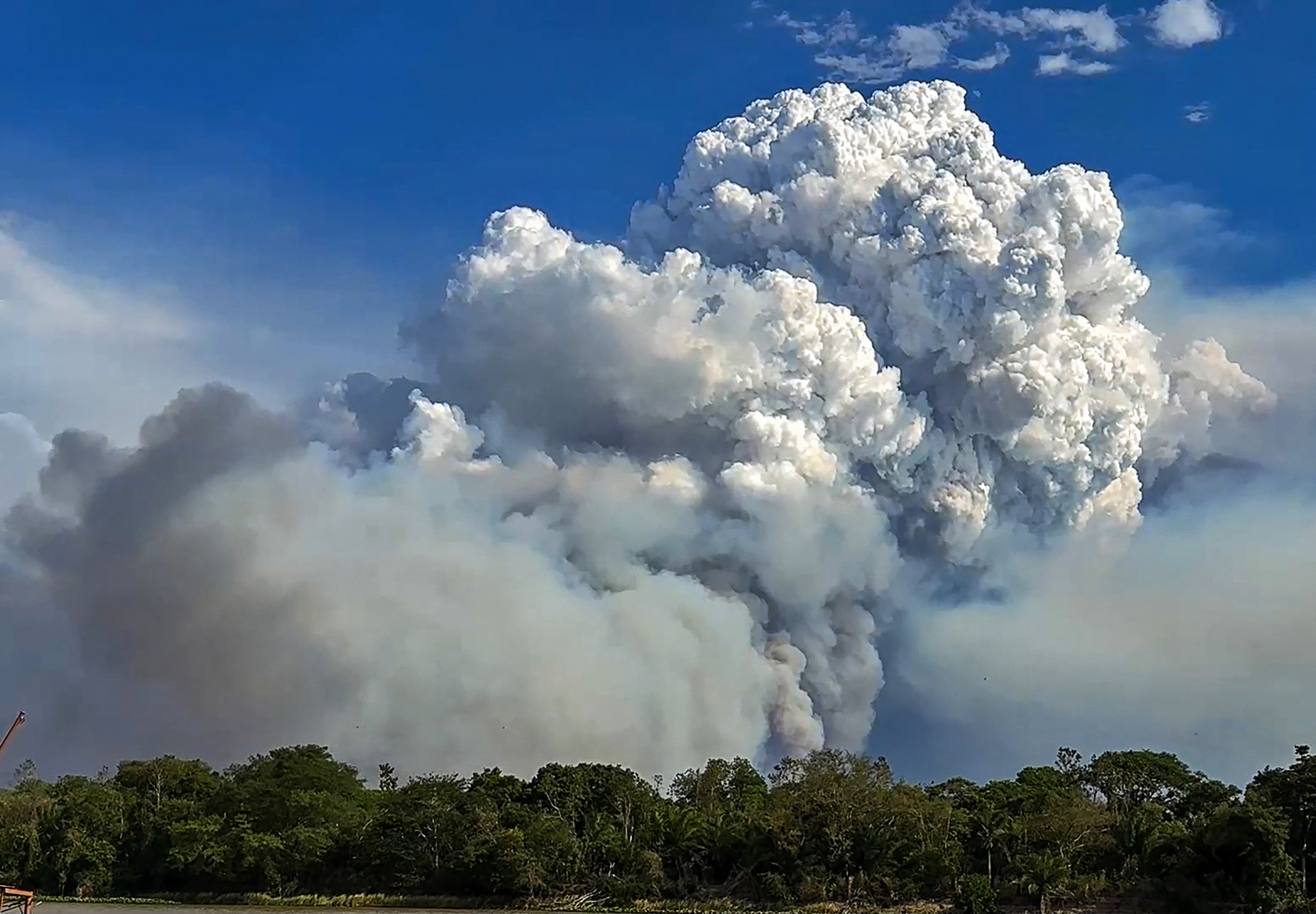 Clouds of smoke billow from forest fires in the Pantanal wetland in Porto Jofre, Mato Grosso State, Brazil.