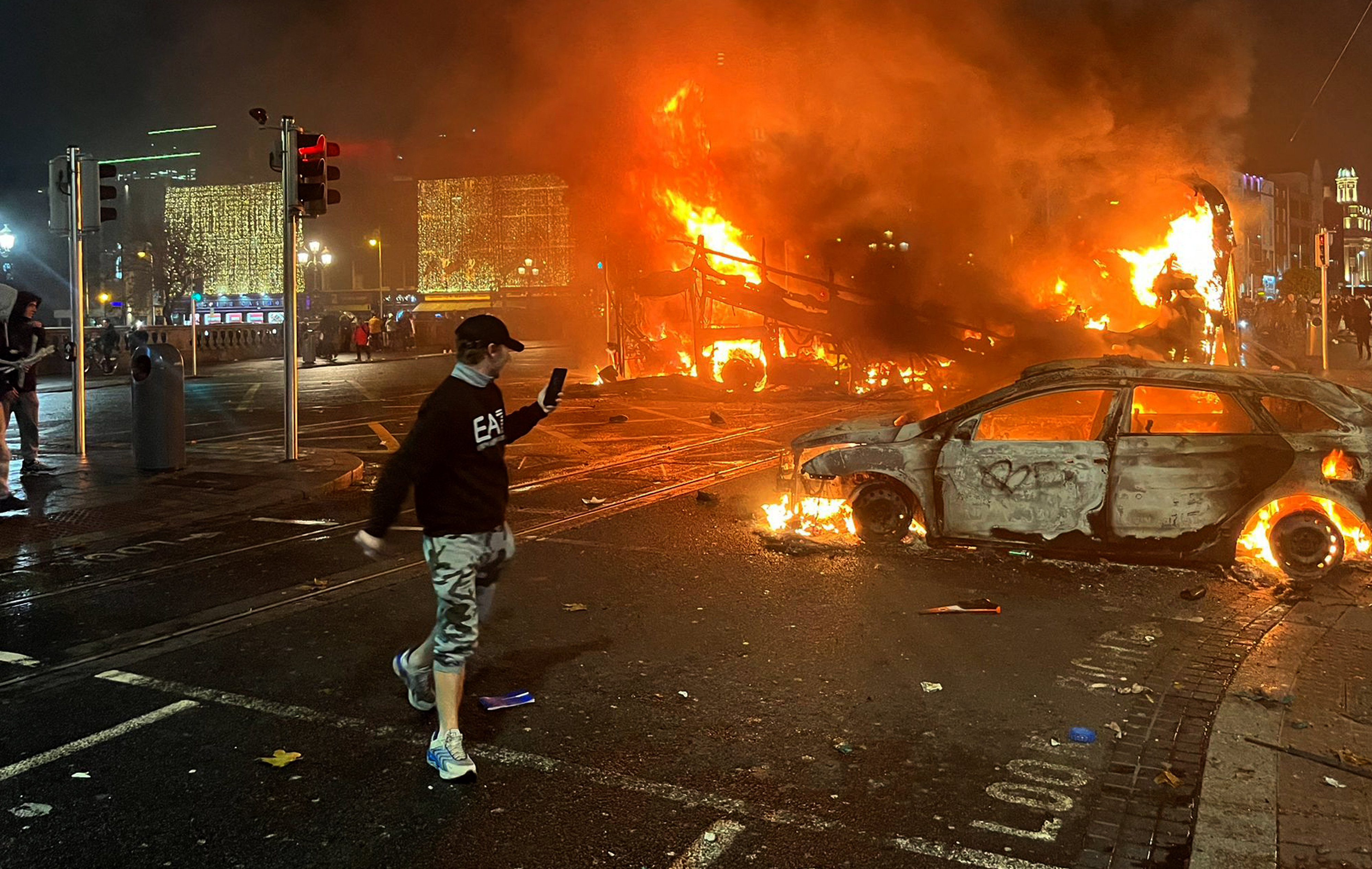 Flames rise from a car and a bus, set alight at the junction of Bachelors Walk and the O'Connell Bridge, in Dublin