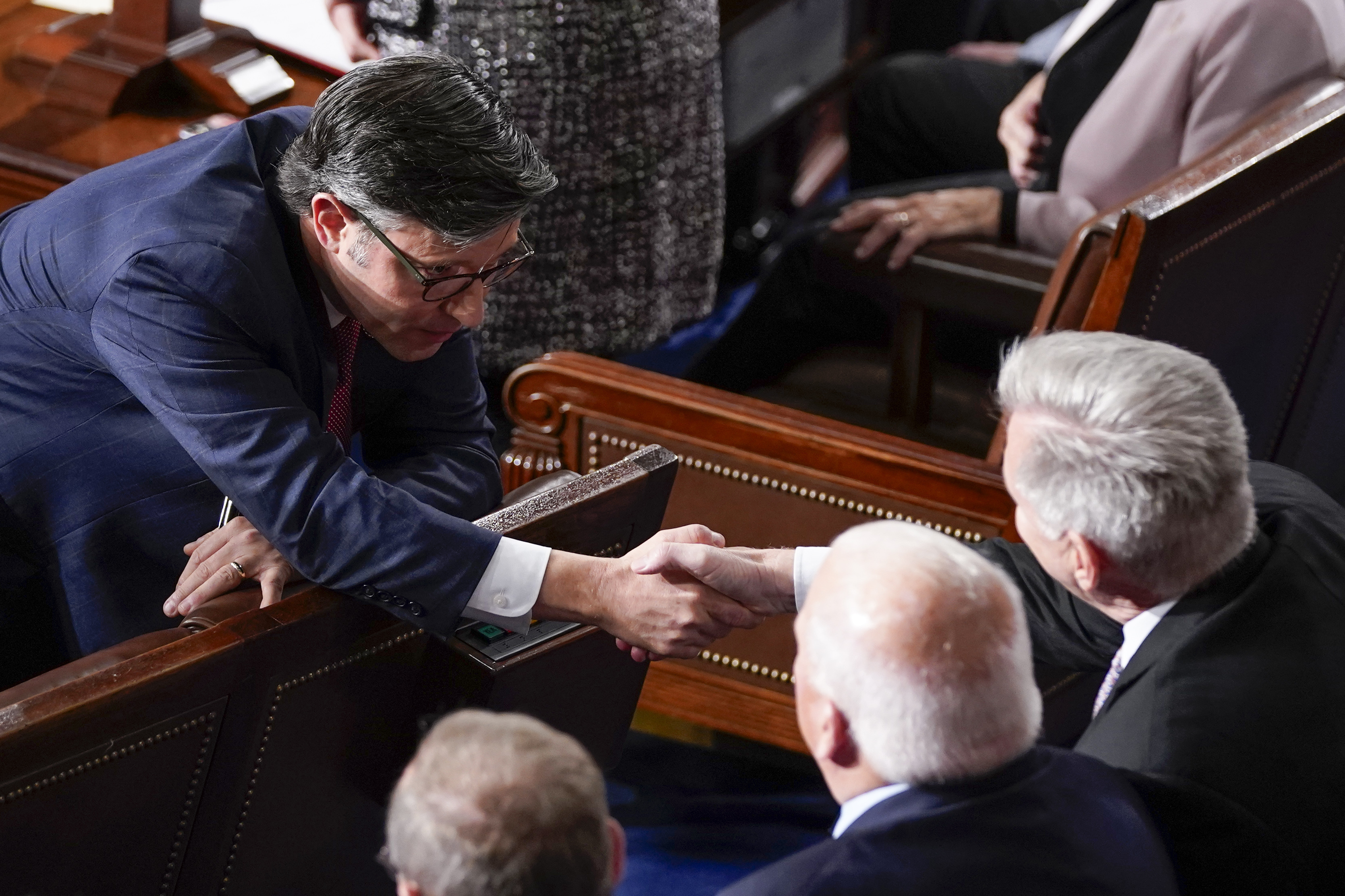 Representative Mike Johnson, left, shakes hands with removed House Speaker Kevin McCarthy before his successful election to the leadership post on October 25