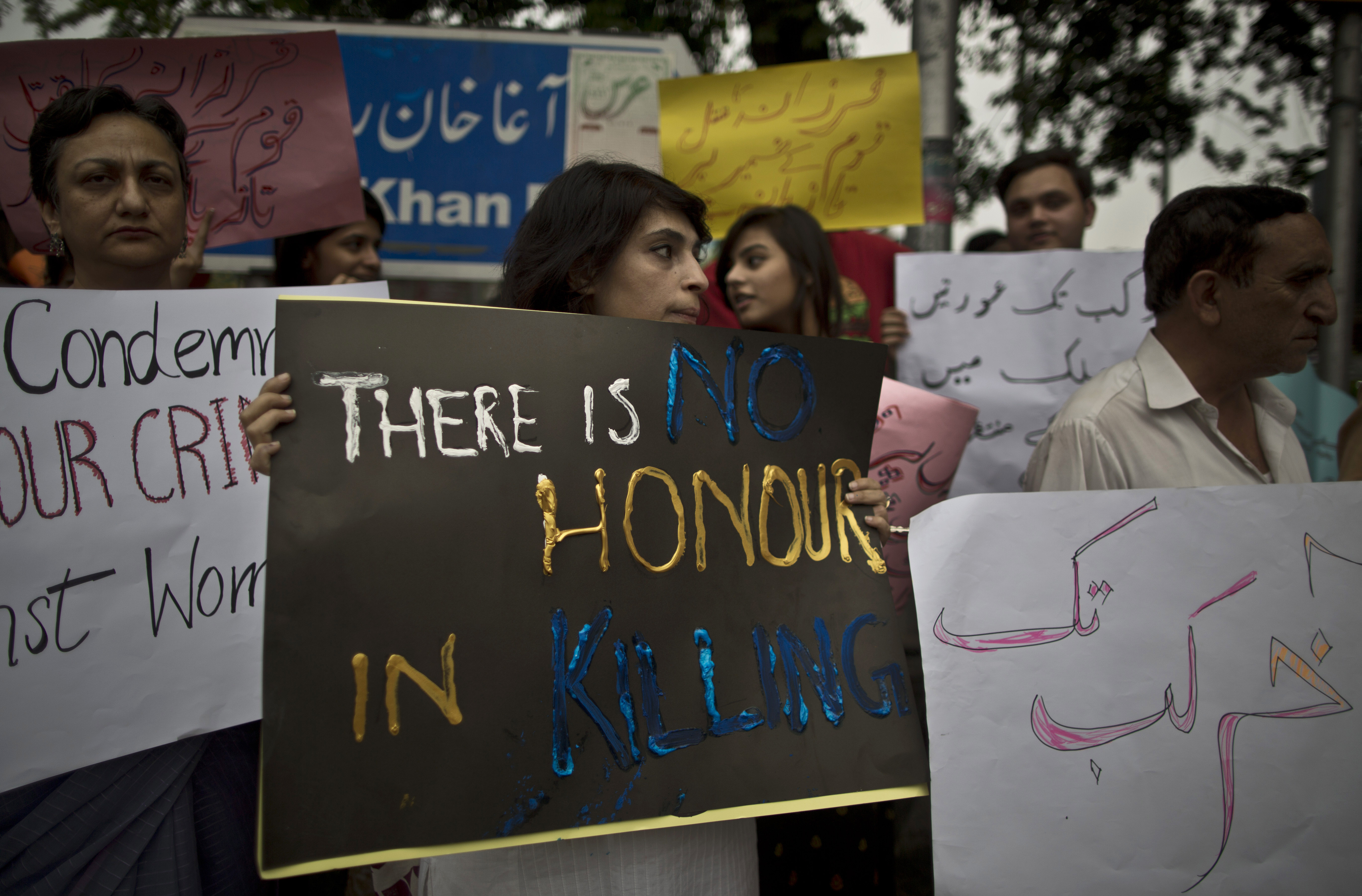 Members of Pakistan's civil society hold banners during a protest to condemn the killing of pregnant woman Farzana Parveen, who was stoned to death in Islamabad, Pakistan, Thursday, May 29, 2014. A senior police official in Pakistan said Mohammed Iqbal, husband of the woman stoned to death by her family earlier this week, was arrested for killing his first wife, though the case against him was withdrawn. Iqbals second wife was bludgeoned to death Tuesday in the eastern city of Lahore by family members. Iqbal and his wife's lawyer said the family was angry because they wanted her to marry someone else. (AP Photo/Muhammed Muheisen)