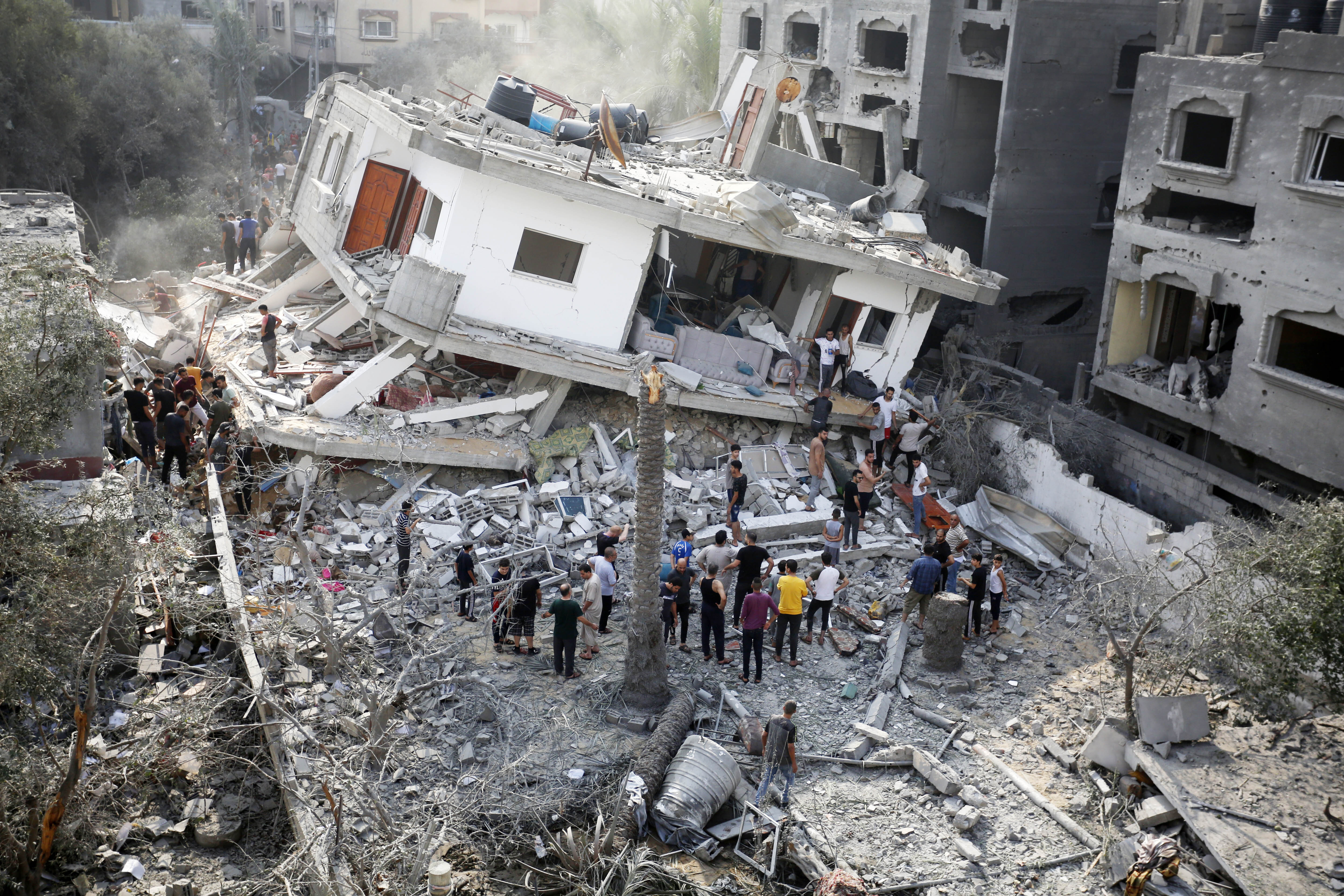Palestinians conduct a search and rescue operation after the attack of the Israeli army at Maghazi refugee camp