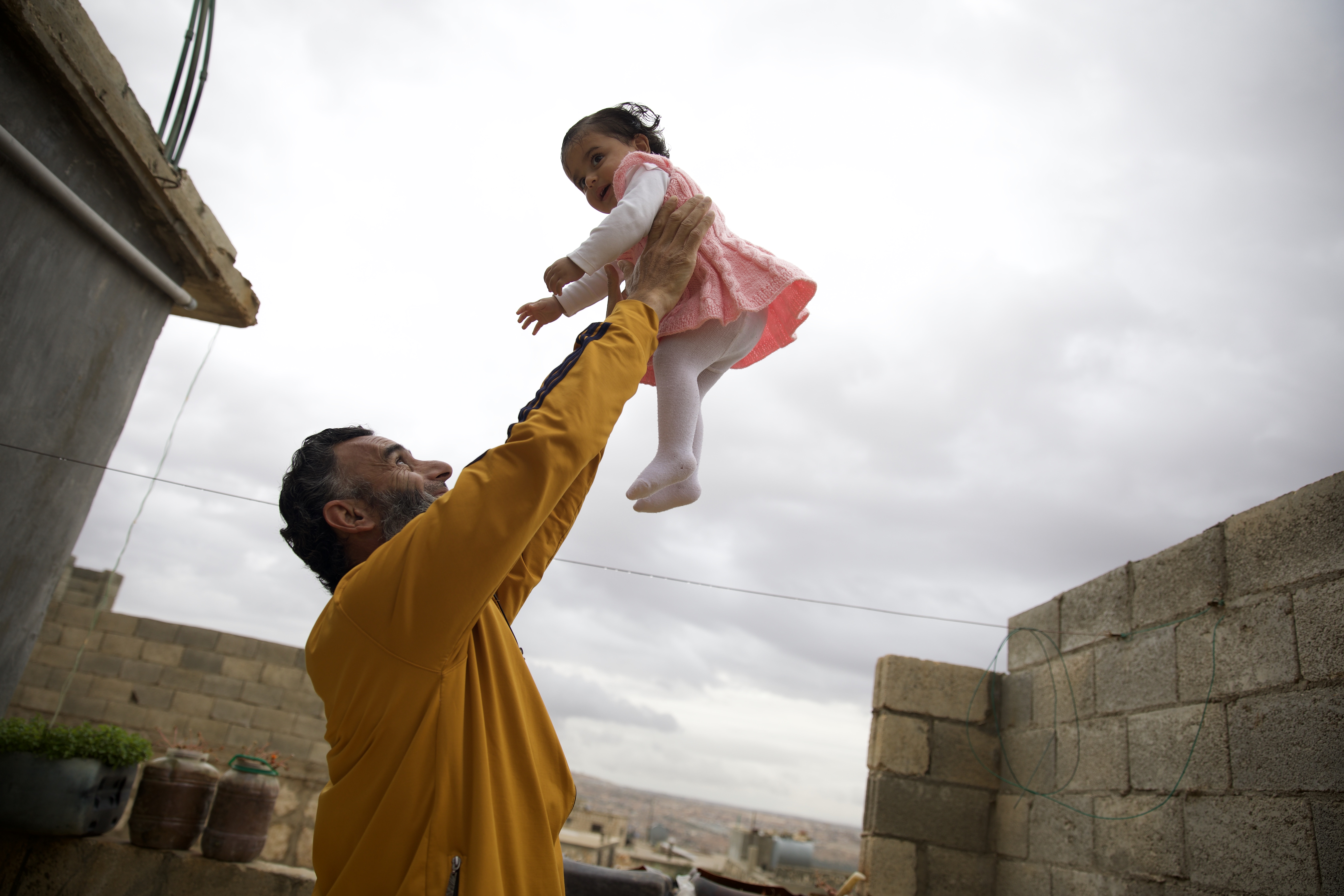 Nader Mohammed Al-Bakri plays with Jouri, who just started taking her first steps and saying Mama and Baba