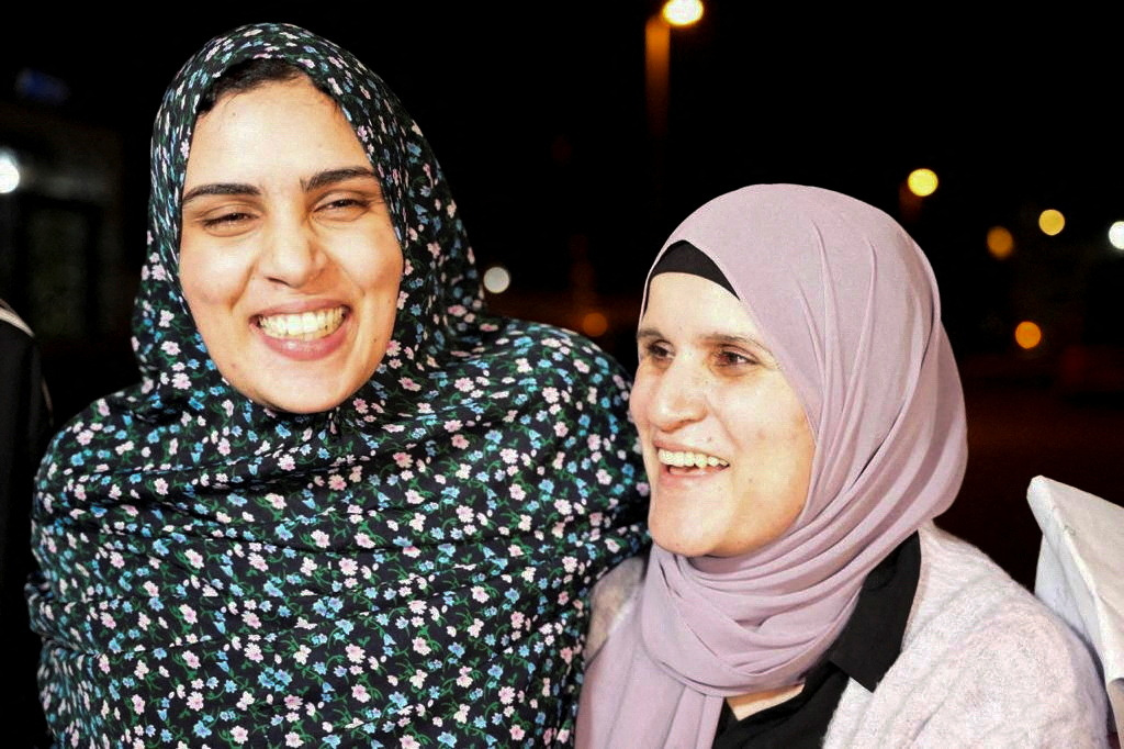Released Palestinian prisoner Marah Baker reacts with a family near her house after hostages-prisoners swap deal between Hamas and Israel, in Jerusalem