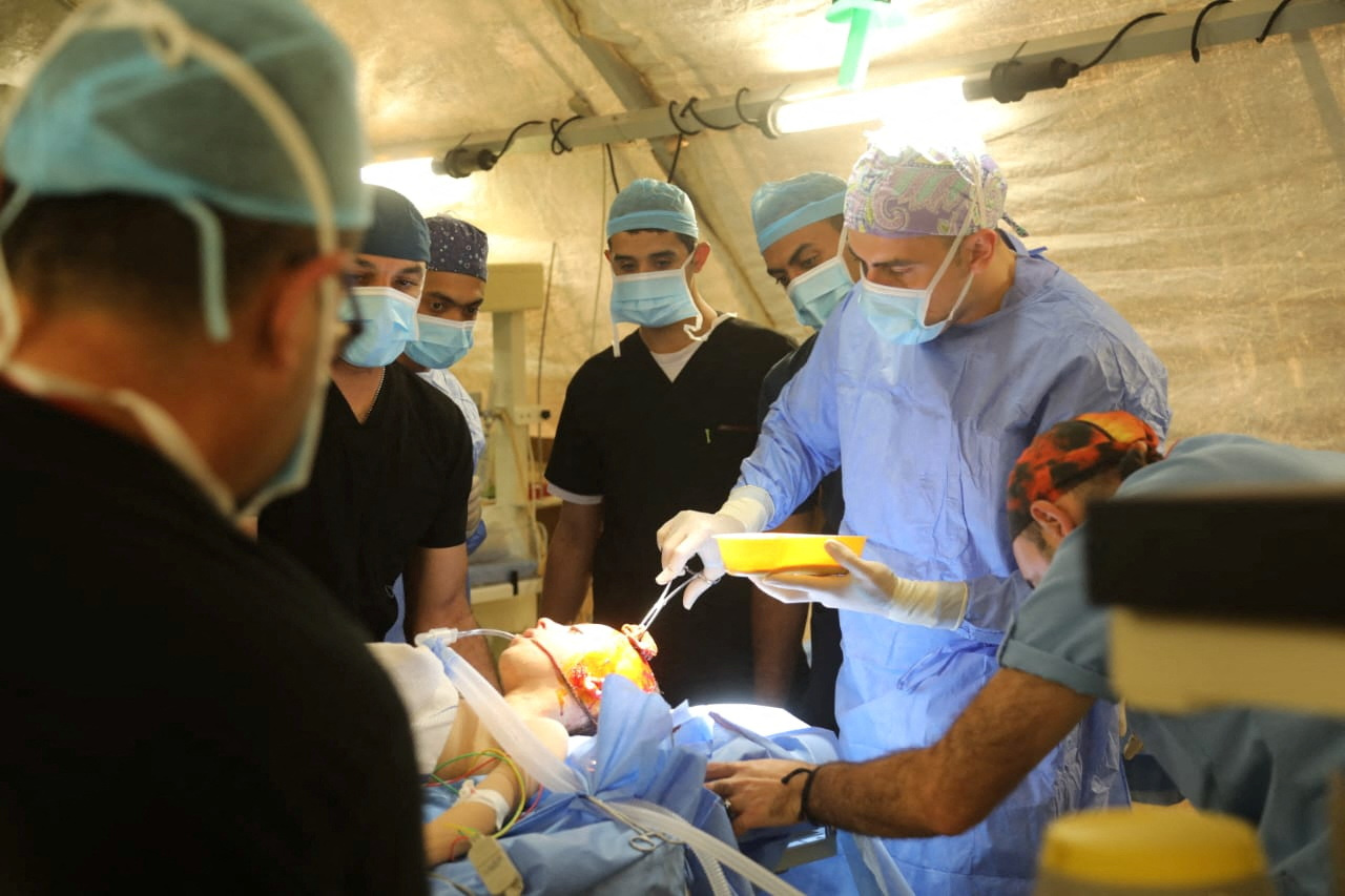 A picture released on December 1, 2023 by the Jordanian Armed Forces shows what it says are health workers assisting an injured child who was transferred from Nasser hospital to the Jordanian private field hospital in Gaza, after a temporary truce expired between Israel and the Palestinian Islamist group Hamas.