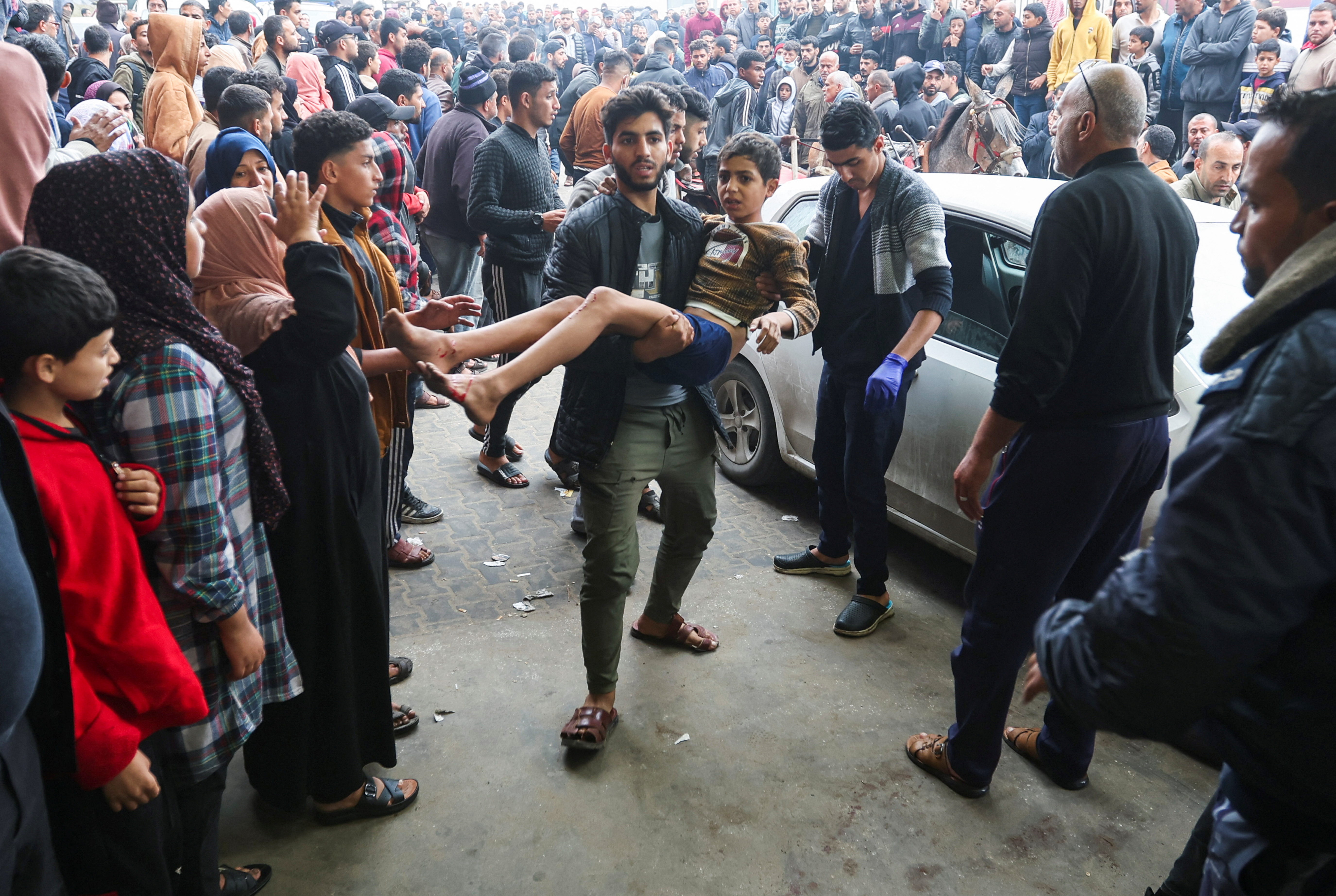 A wounded Palestinian child is brought into Nasser hospital,