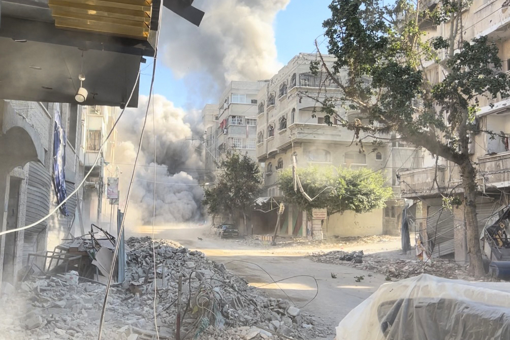 Smoke rises after the Israeli airstrikes hit a residential building and caused casualties in Tal al-Zaatar area, northern Gaza on December 03