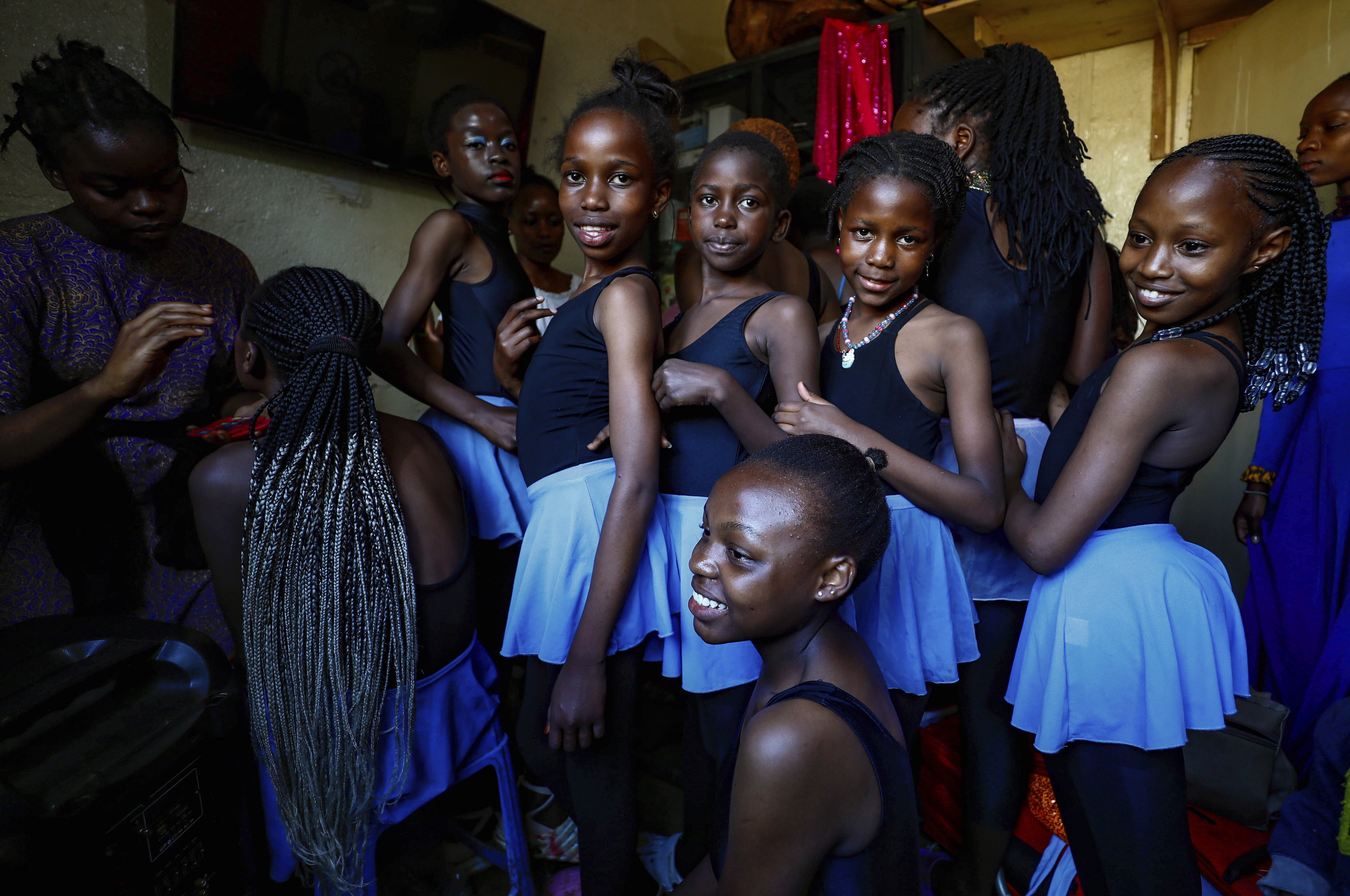 Young girls get their makeup applied at