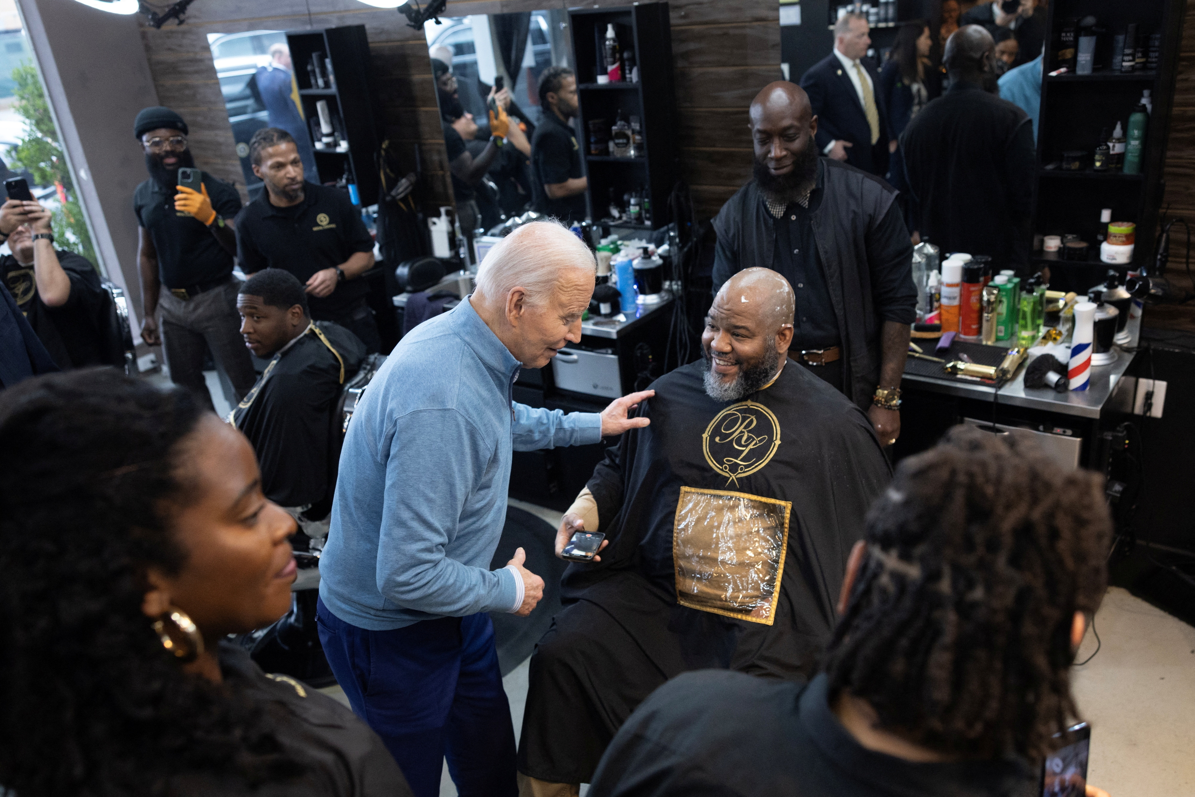US President Joe Biden greets a patron during an unannounced visit to the Regal Lounge barber shop in Columbia, South Carolina