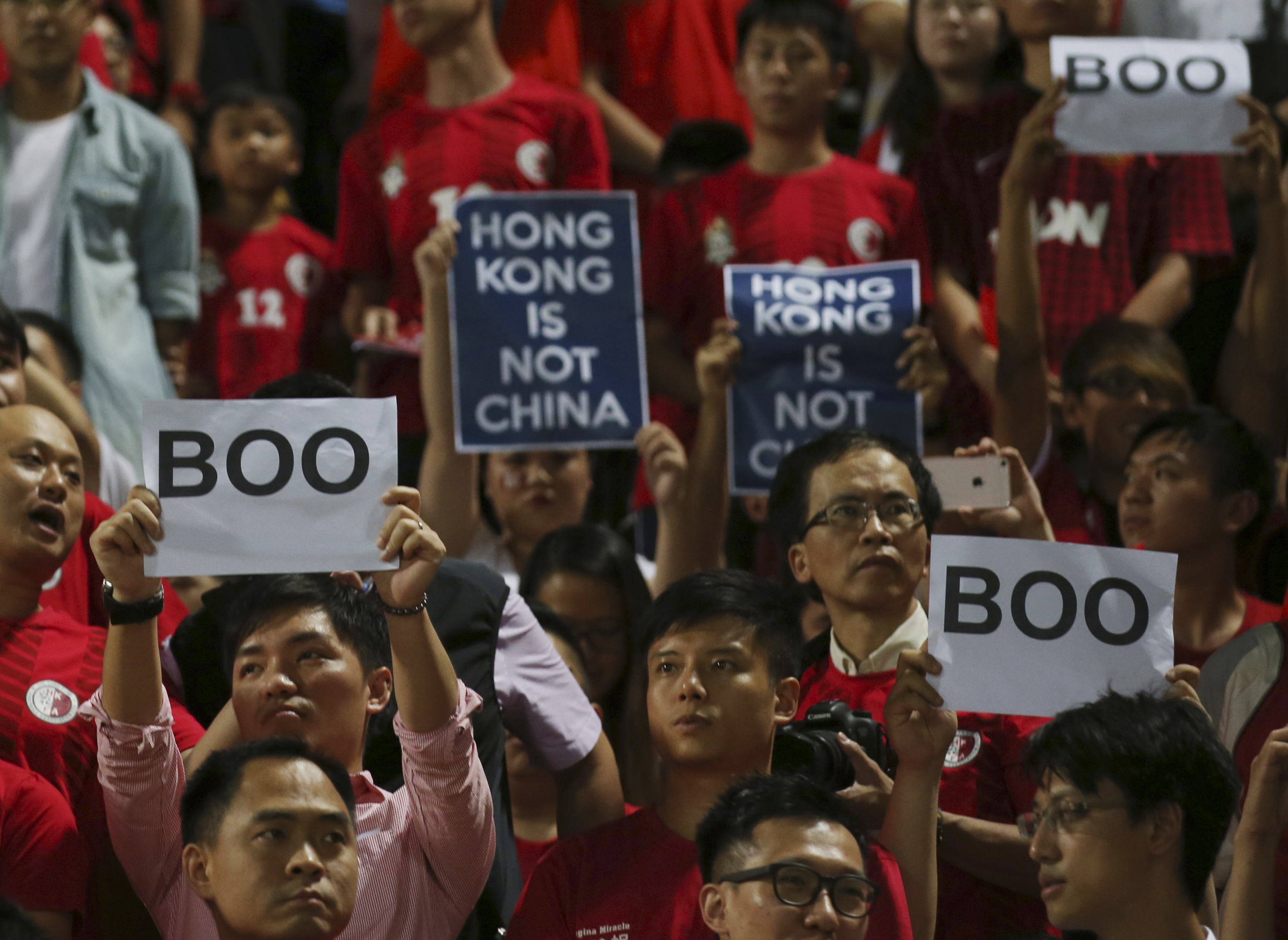 Hong Kong football fans boo the Chinese national anthem and hold placards saying ‘Hong Kong is not China’ during the 2018 World Cup Asian qualifying match against China in Hong Kong on Tuesday, November 17, 2015