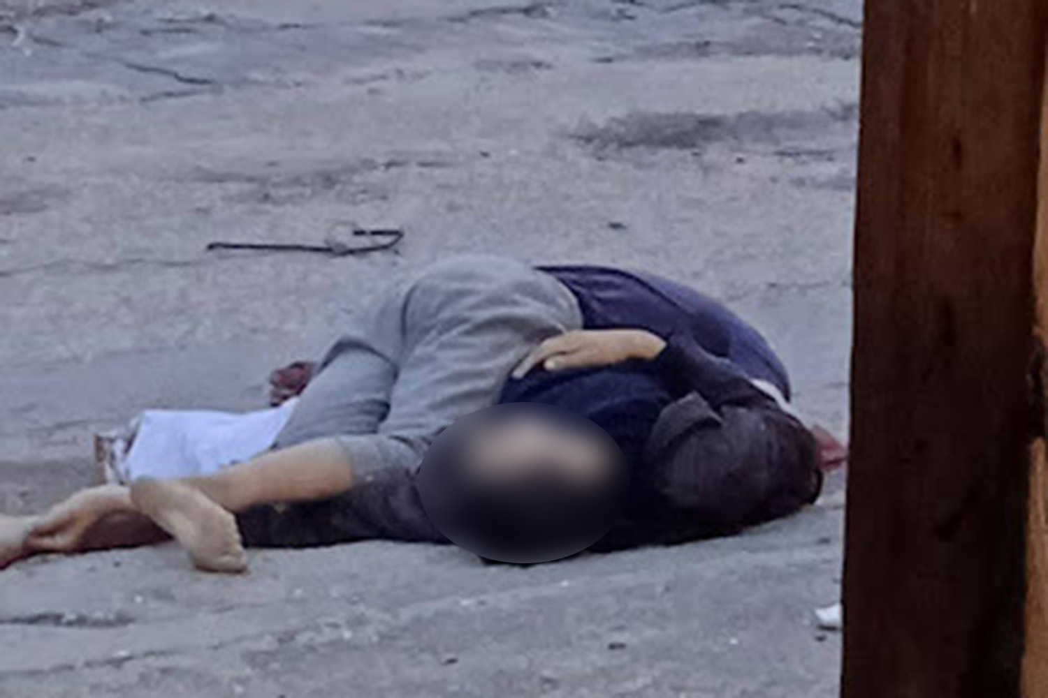 This photo taken by Ahmed Barbakh shows his two brothers shot on the street, Ramez was shot in the heart and fell on top of his 13-year-old brother who had been shot repeatedly. The white flag is visible where it fell from Nahedh’s hand [Courtesy of the Barbakh family]
