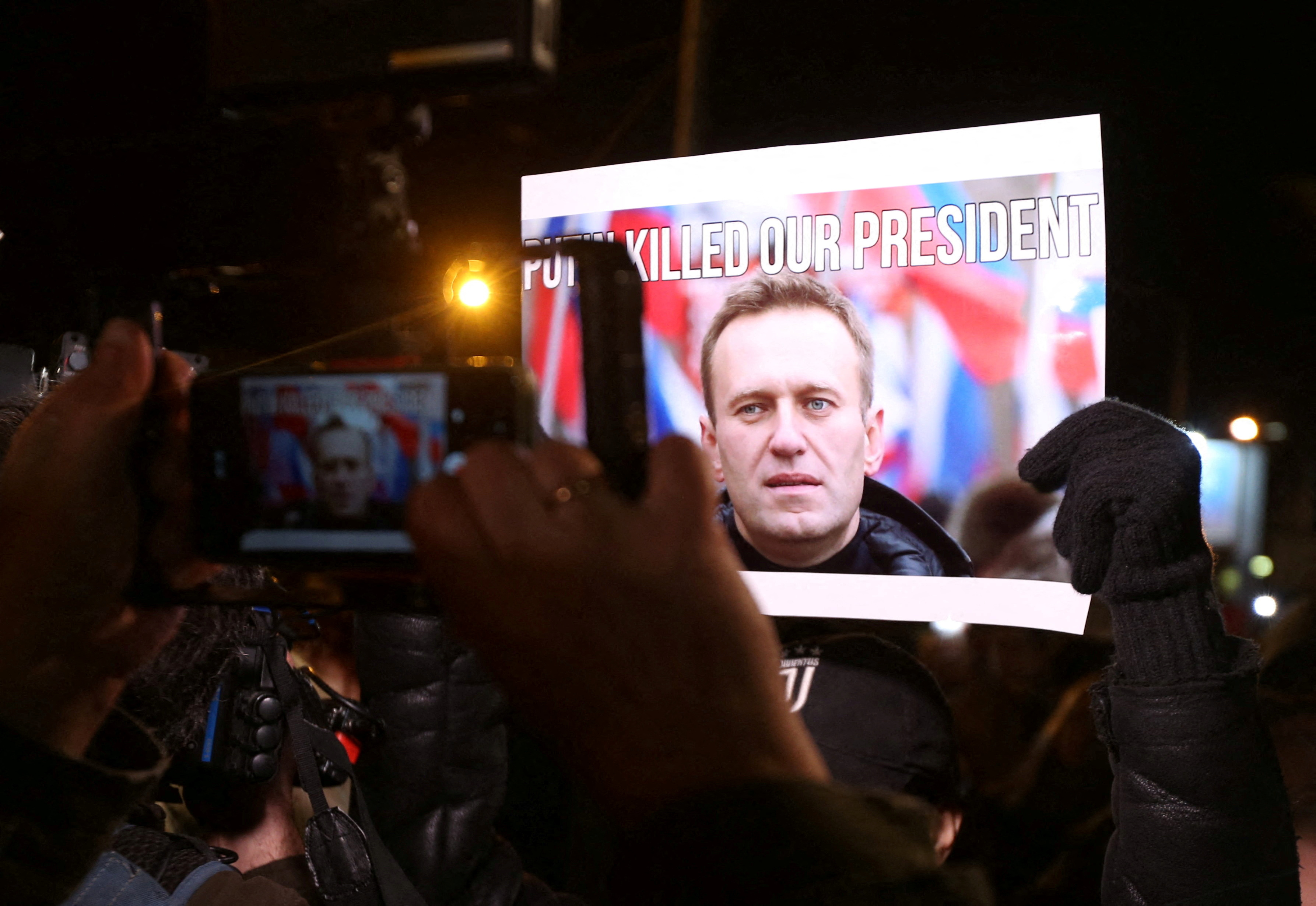 People attend a rally following the death of Russian opposition leader Alexei Navalny, in Tbilisi, Georgia