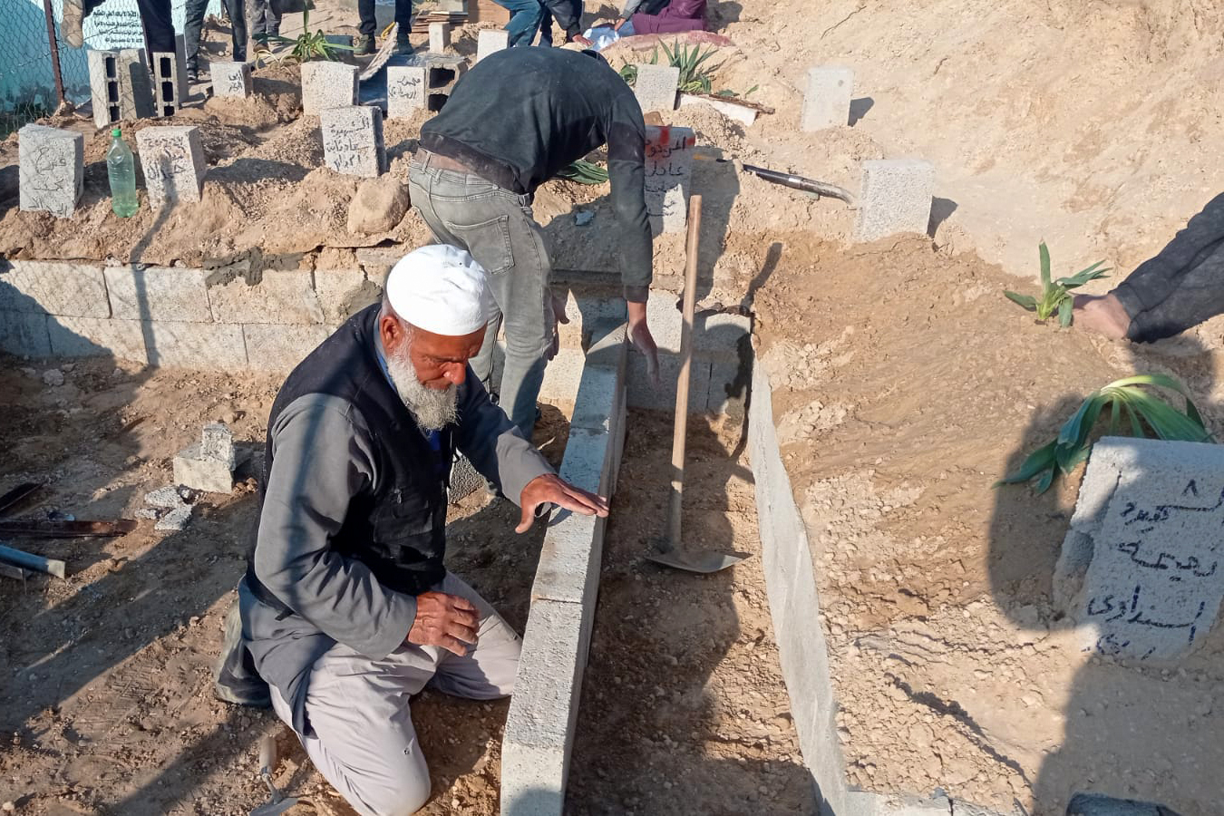 Graves are built in the ground, then covered up level with a marker on top if the identity of the person or people buried in them is known