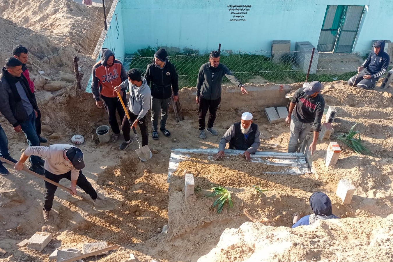 Abu Jawad and his fellow volunteers working at the cemetery