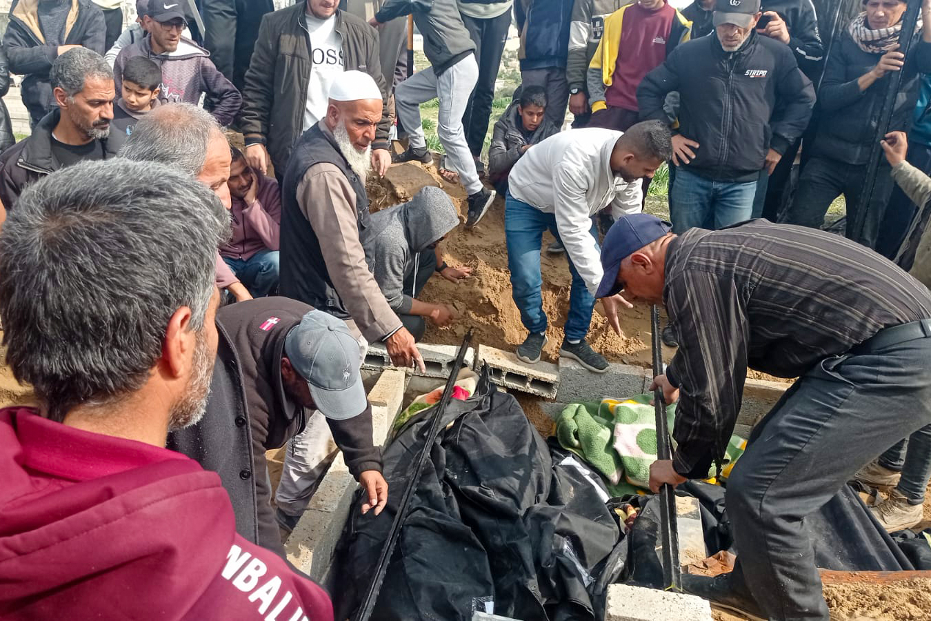 Abu Jawad and his team try to make a quick mass grave after a massacre in Deir el-Balah resulted in tens of deaths