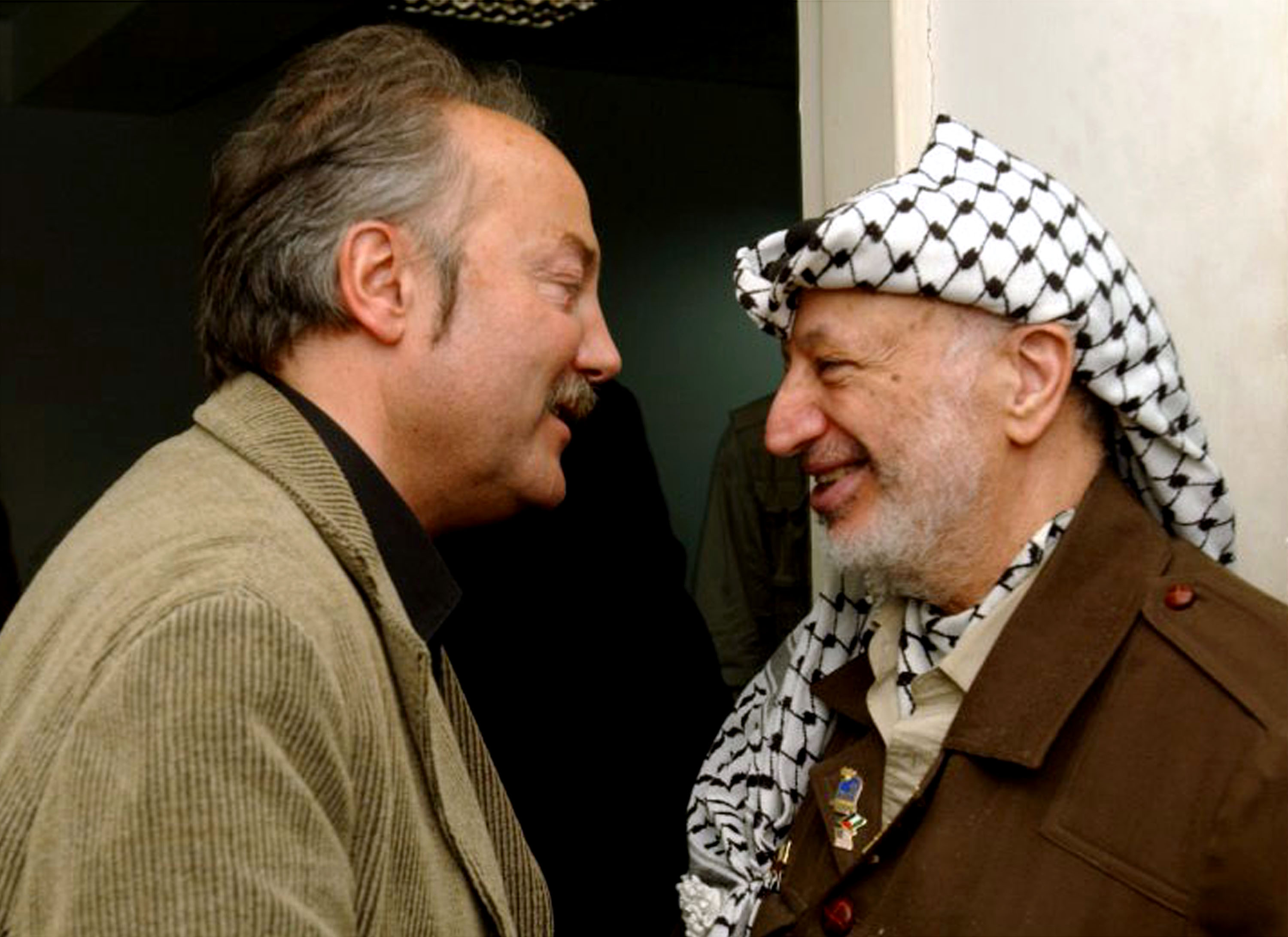 Palestinian leader Yasser Arafat, right, welcomes British Member of Parliament and peace activist George Galloway, May 8, 2002, in his office in the West Bank city of Ramallah
