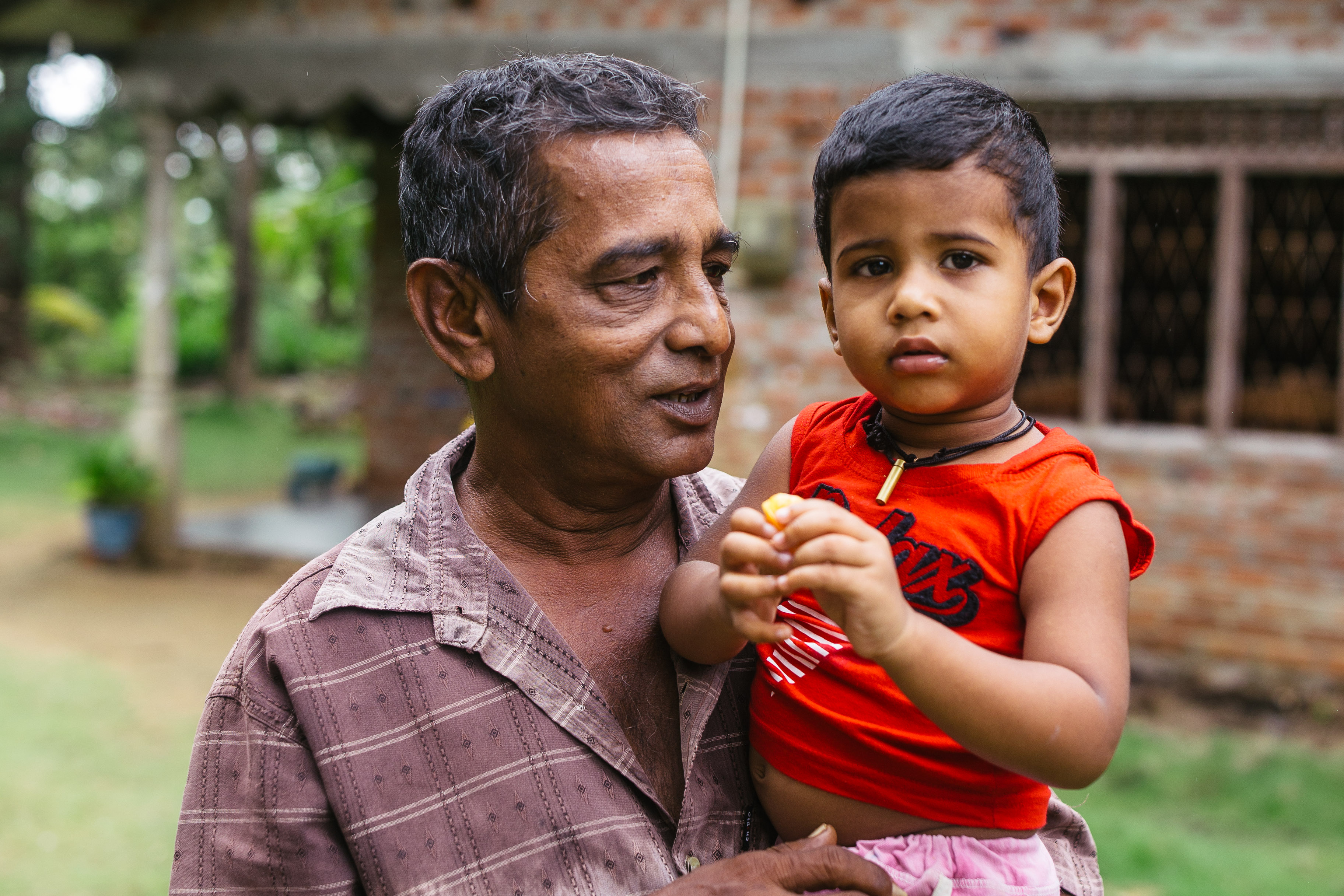 Rice farmer Gamini Sunil Thennakoon, 63, pictured with his granddaughter, suffers from unexplained kidney disease
