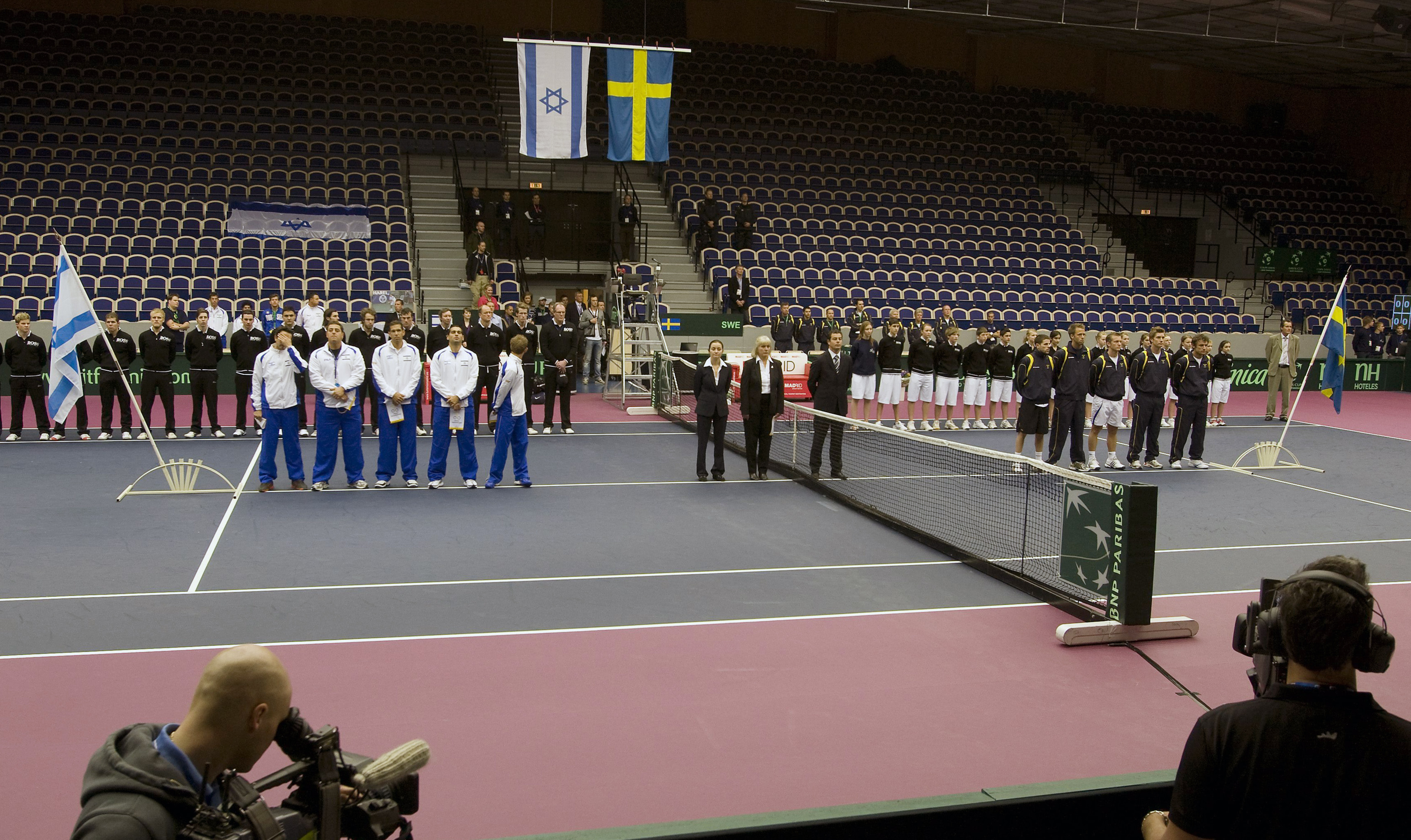 Cameramen film Israel's (left) and Sweden's (right) Davis Cup team in the Baltic Arena in Malmo on March 6, 2009