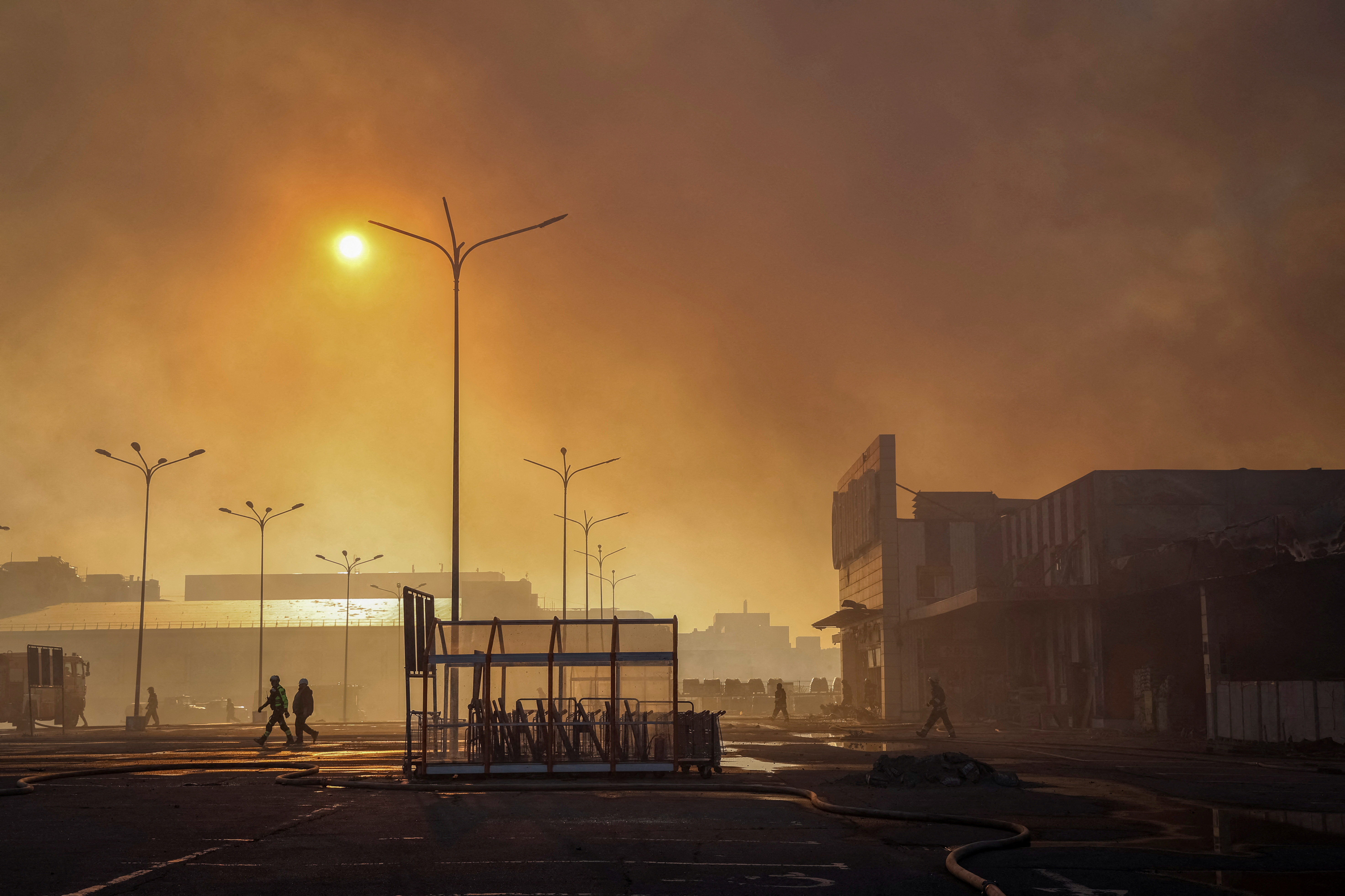 Firefighters work at a site of a household item shopping mall hit by a Russian air strike, amid Russia's attack on Ukraine, in Kharkiv, Ukraine May 25