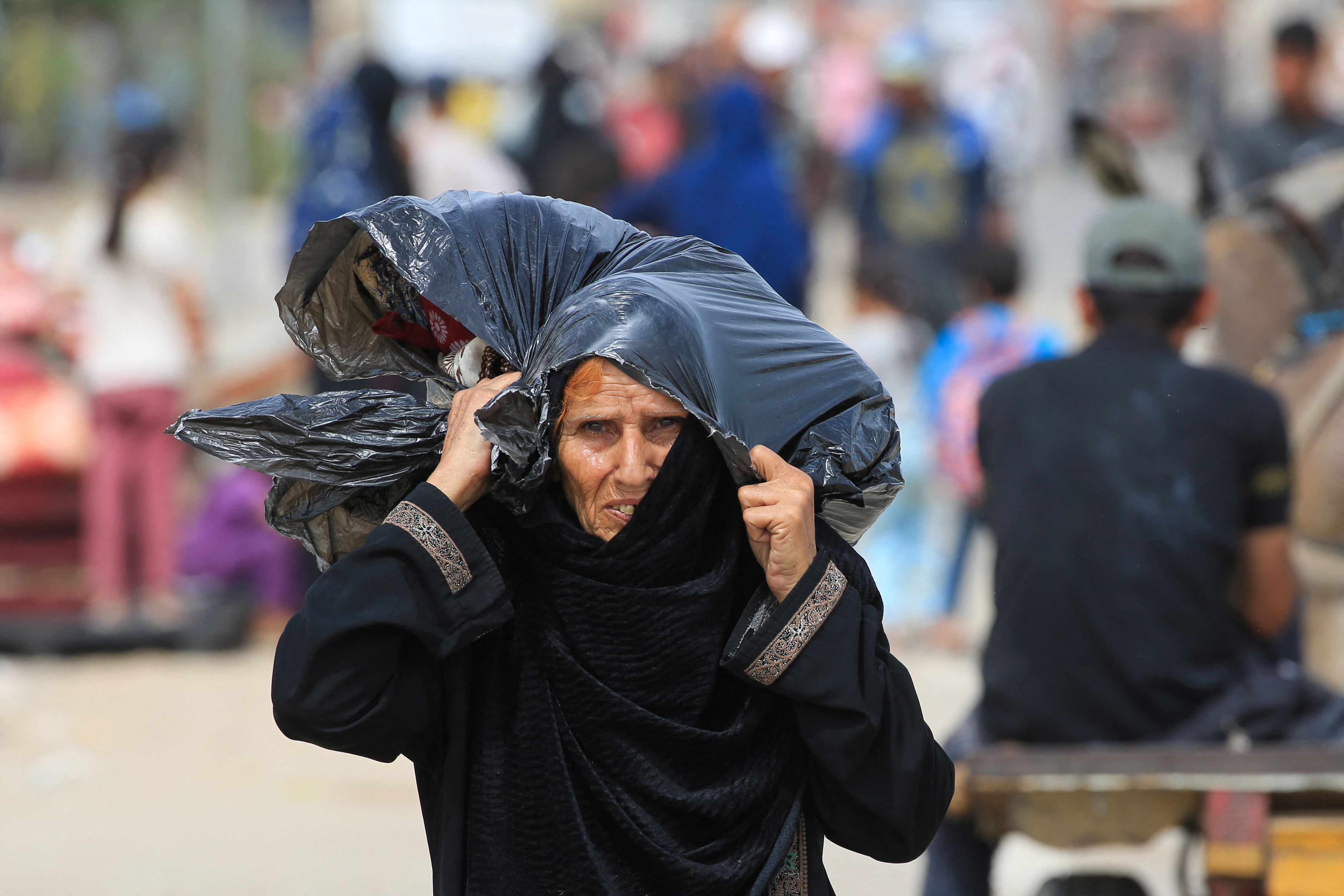Palestinians flee the area of Tal al-Sultan in Rafah
