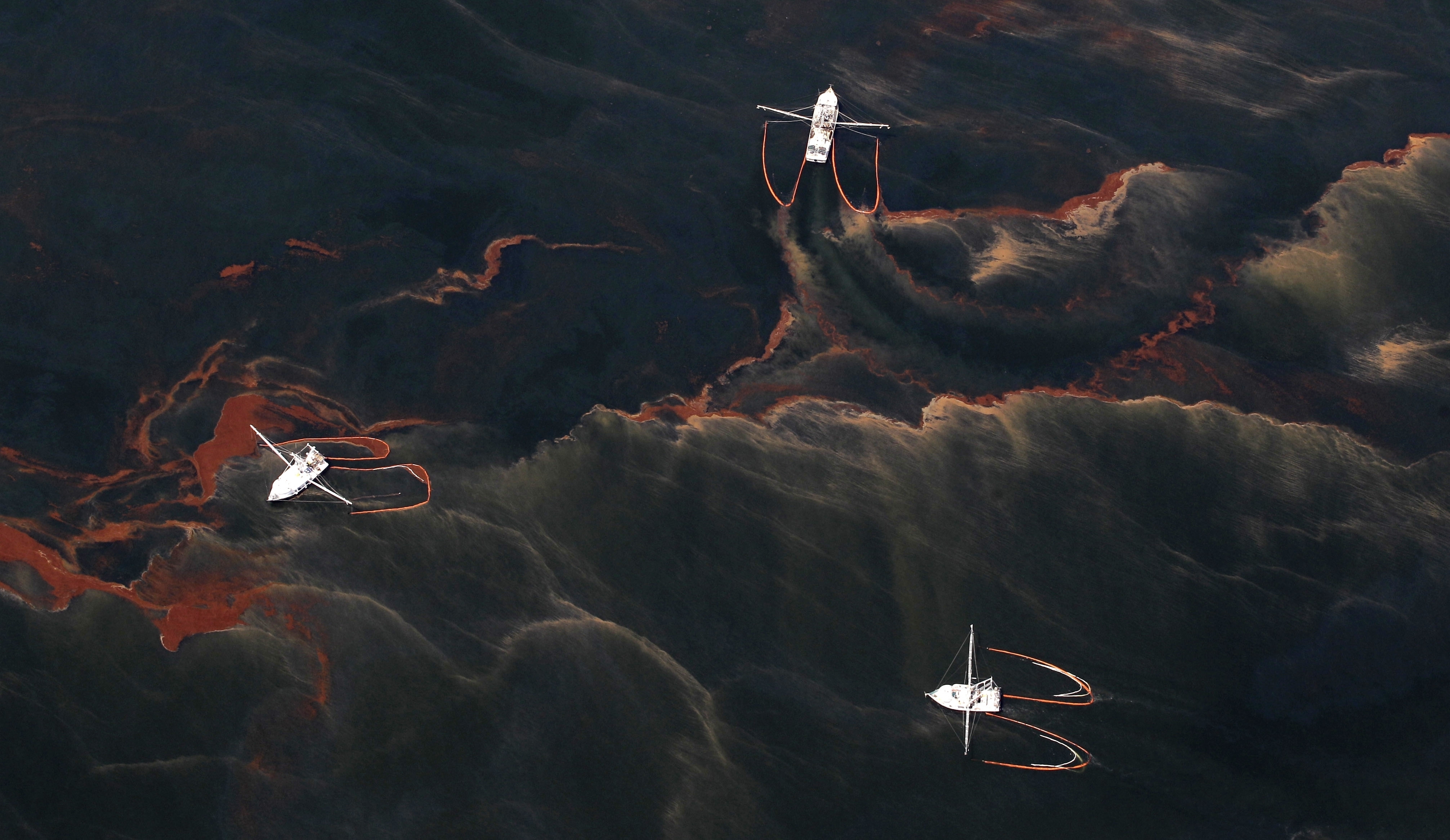 an aerial view of an ocean full of black and orange