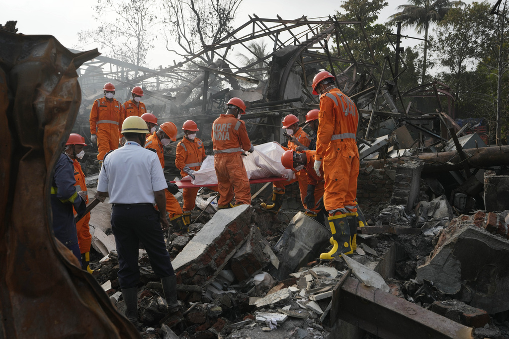 National Disaster Response Force rescuers carry the dead body of a person after an explosion and fire at a chemical factory in Dombivali near Mumbai, India