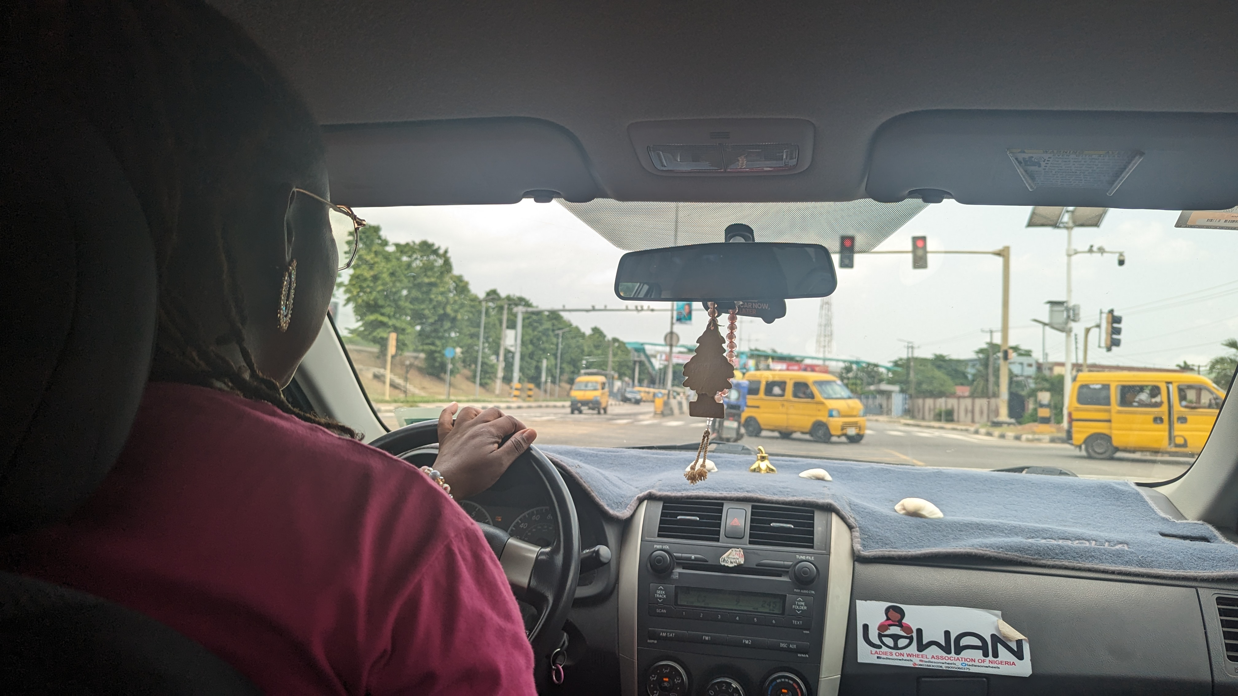 A woman drives an e-hailing taxi in Lagos