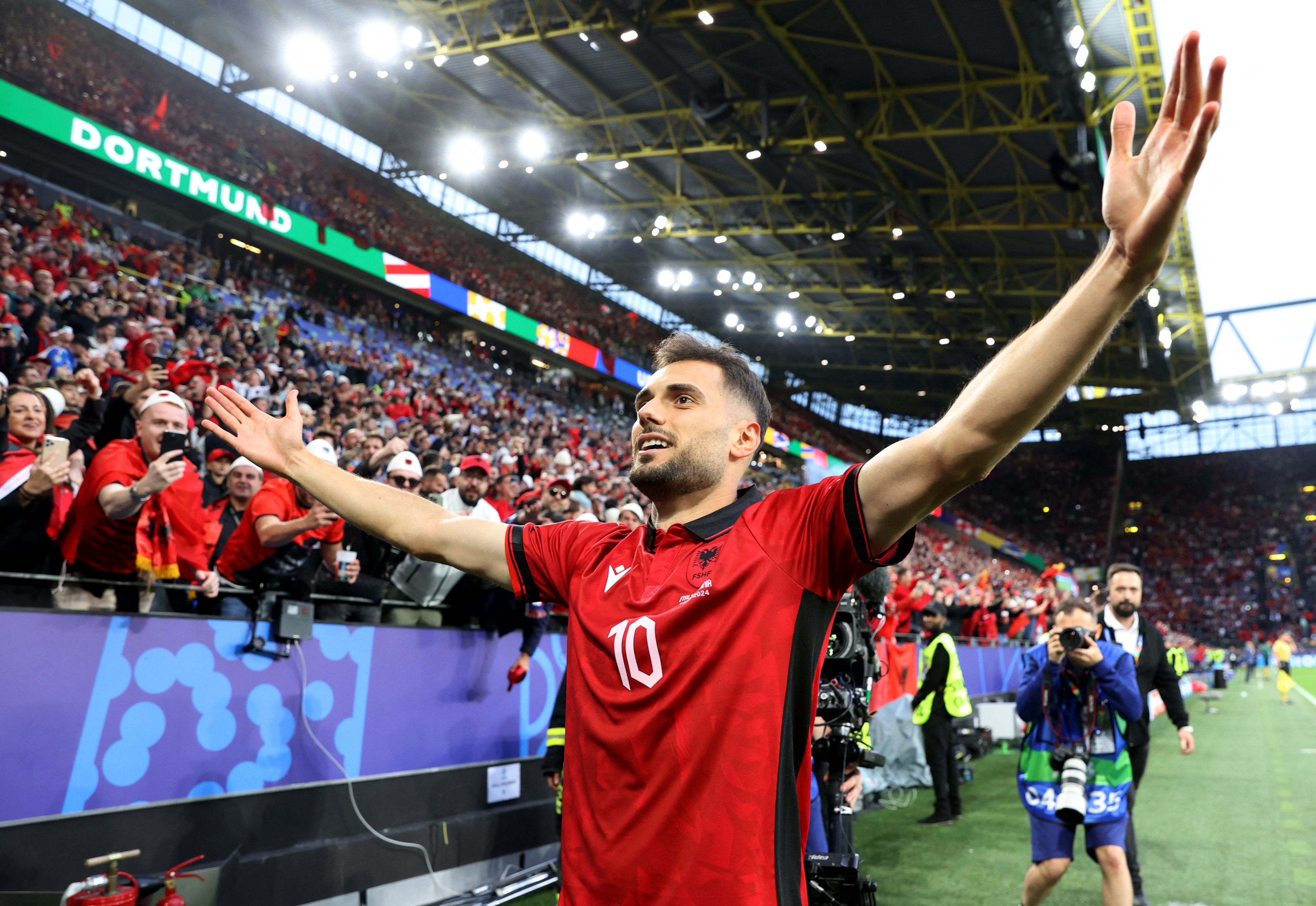 Football player celebrates with fans.