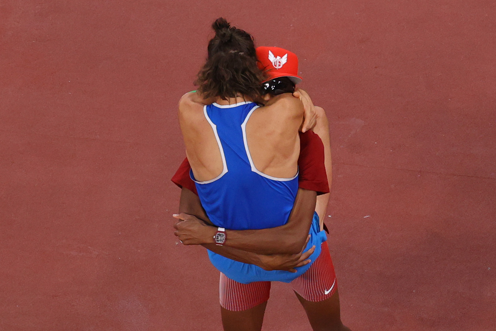 Italy’s Gianmarco Tamberi and Mutaz Essa Barshim of Team Qatar embrace after they decided to share the gold medal in the high jump final at the Tokyo Olympics 2020