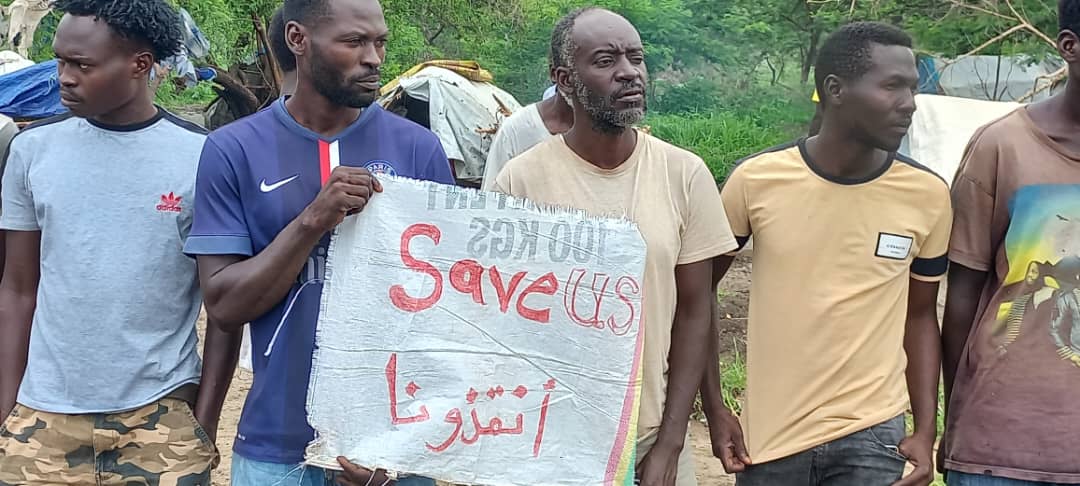 Sudanese refugees hold a sign that reads ‘save us’ as they protest poor conditions and the lack of protection in Ethiopia