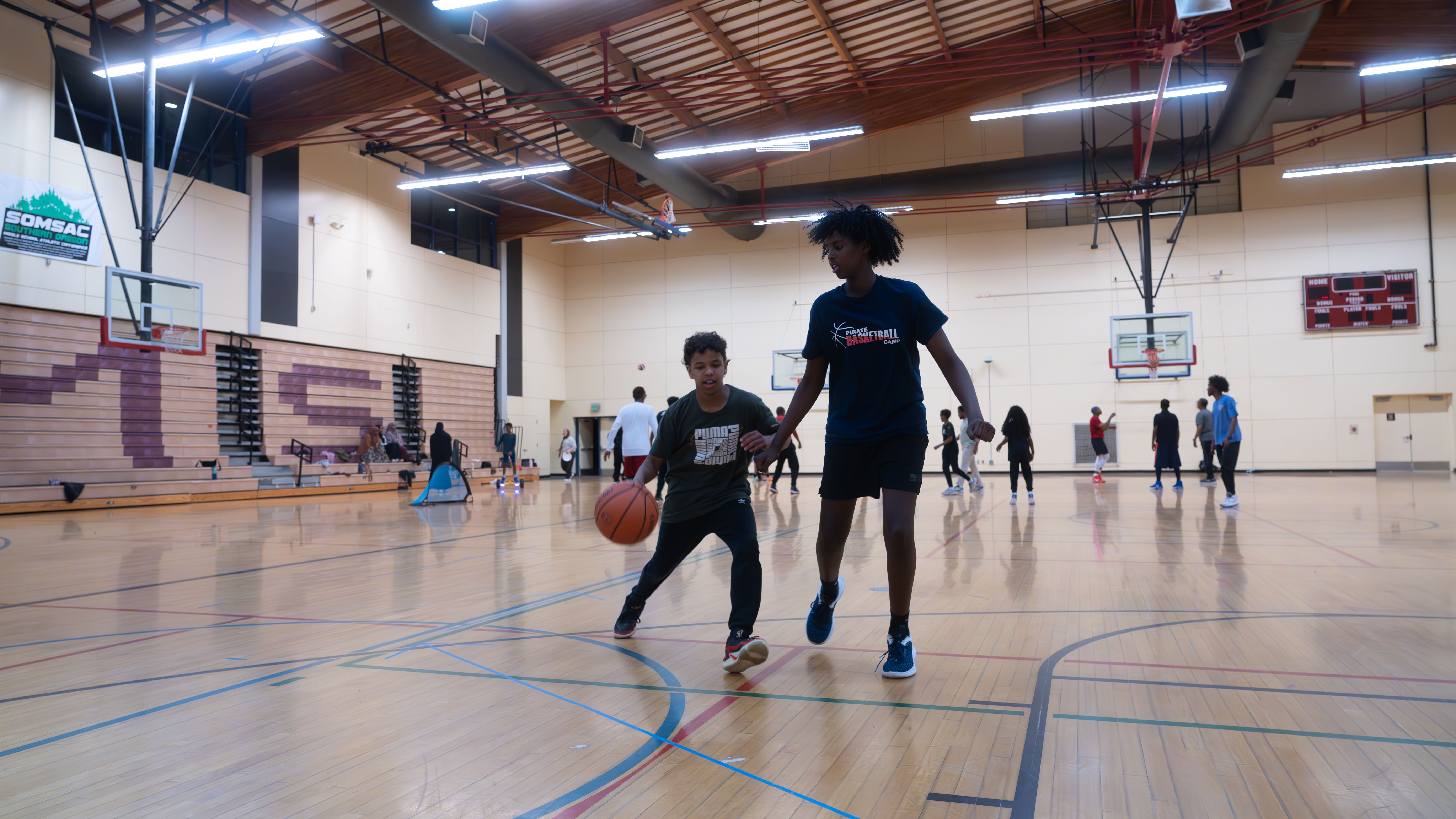Two children who have been attending the annual meet-up since they were babies play a game of basketball