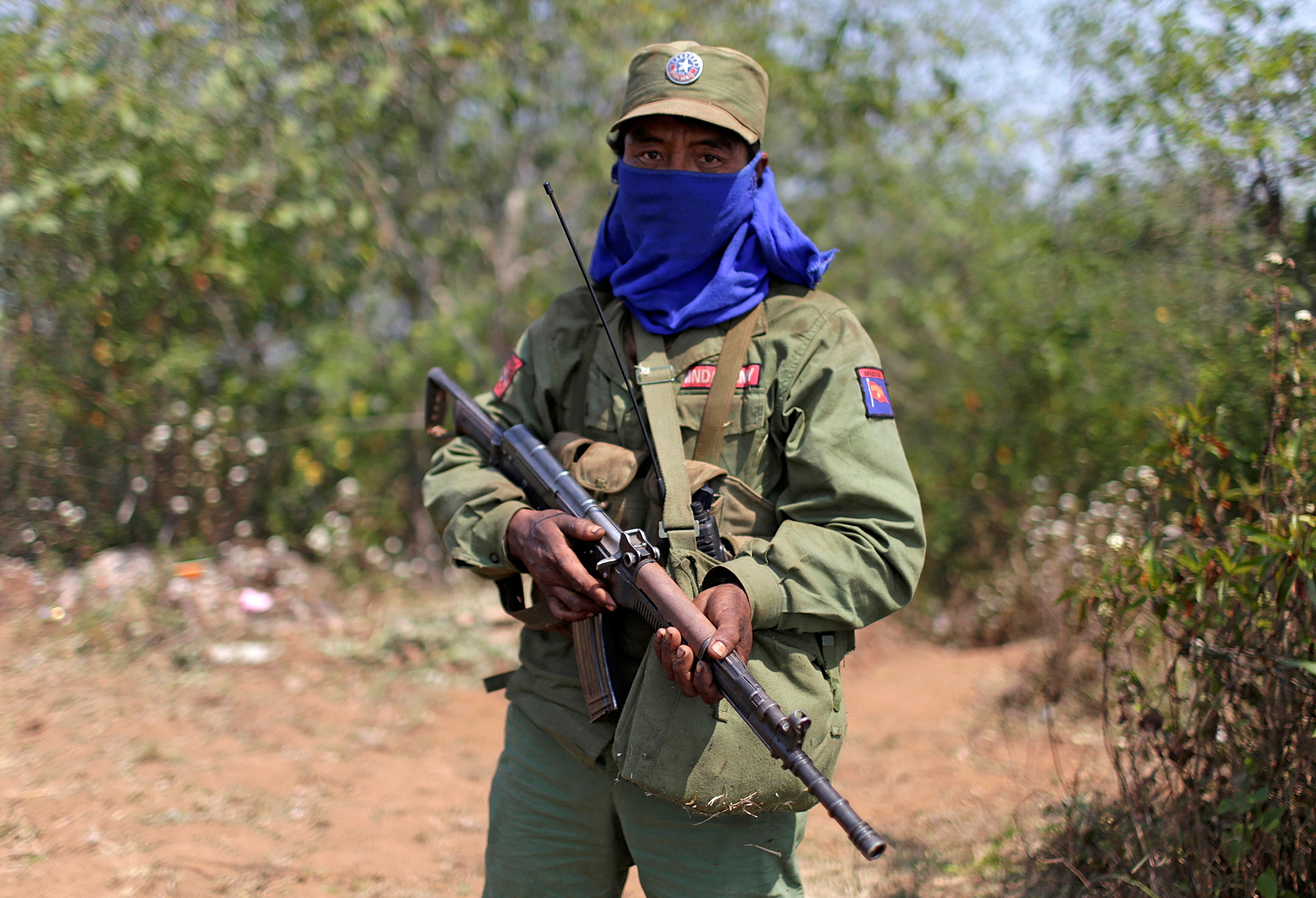 An MNDAA soldier. He is carrying his rifle.