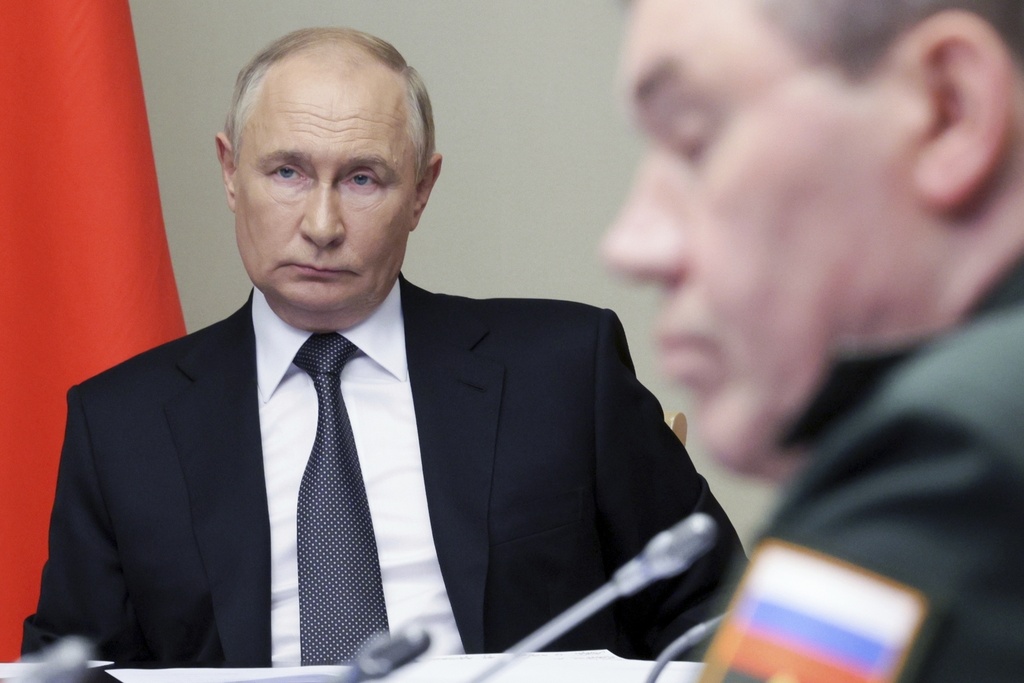 Russian President Vladimir Putin, left, leads a meeting with top security and defense officials