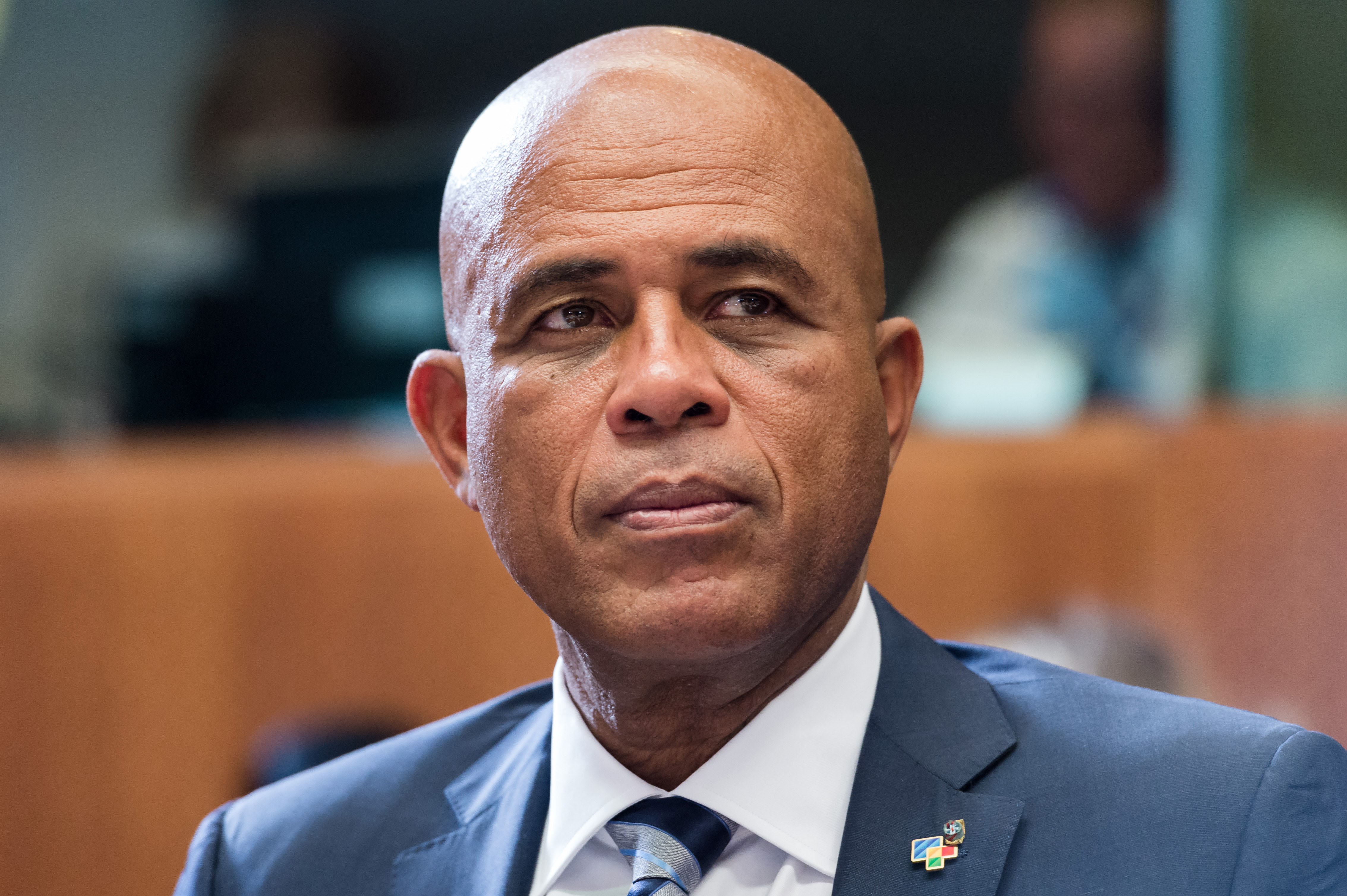 FILE - In this June 10, 2015 file photo, Haiti's President Michel Joseph Martelly waits for the start of a round table meeting at the EU-CELAC summit in Brussels. Hostile comments made by Martelly to a woman at a campaign rally in Haiti have prompted a party in his coalition to remove three officials from his government. Martelly was at a rally in late July 2015 when a woman complained that his government failed to bring electricity to her community. Haitian media reported that he told her in Haitian Creole to go get a man and go in the bushes to have sex. (AP Photo/Geert Vanden Wijngaert, File)