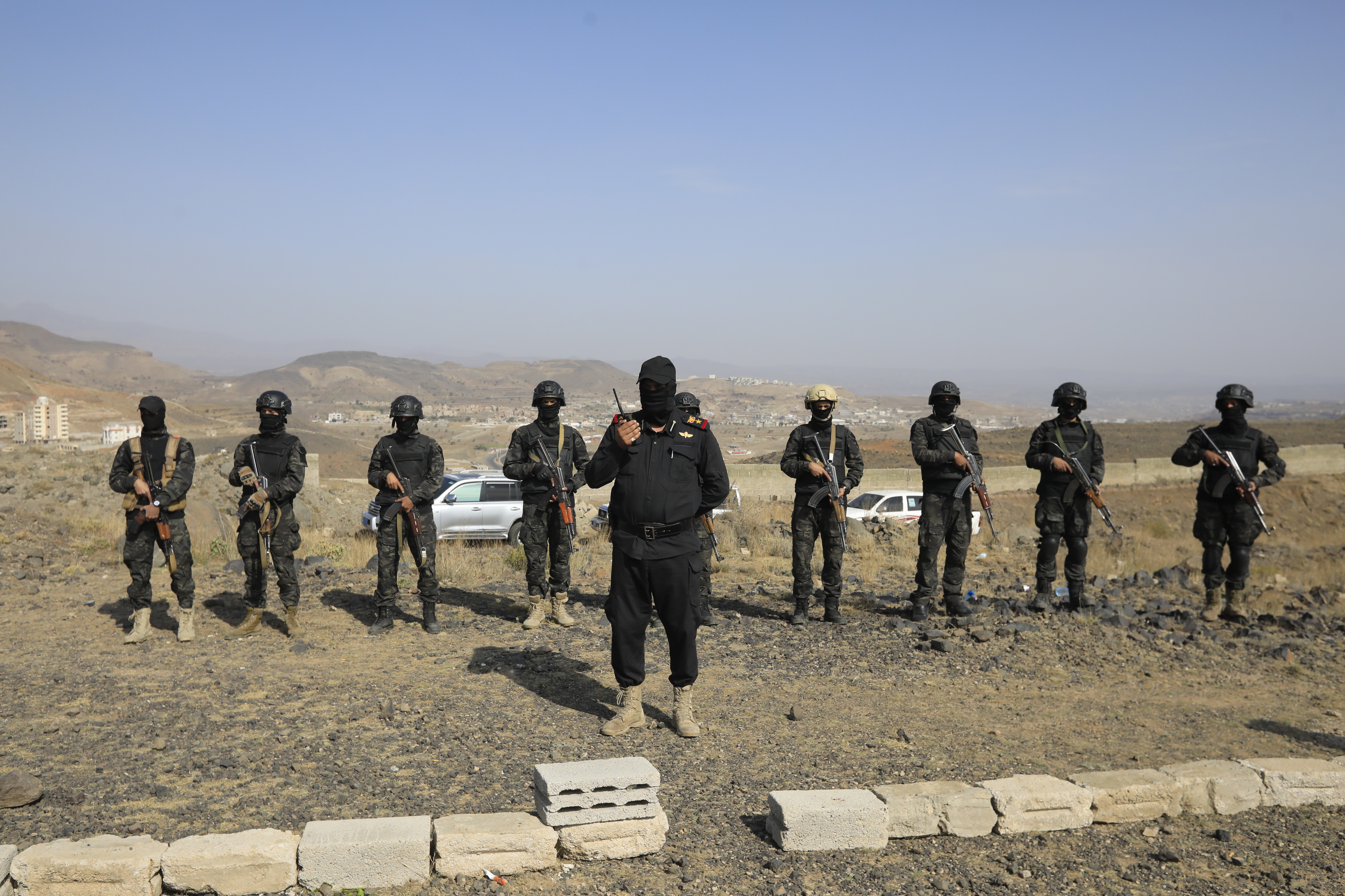 Houthi soldiers gather for a patrol on a mountain overlooking the outskirts of Sana'a, Yemen