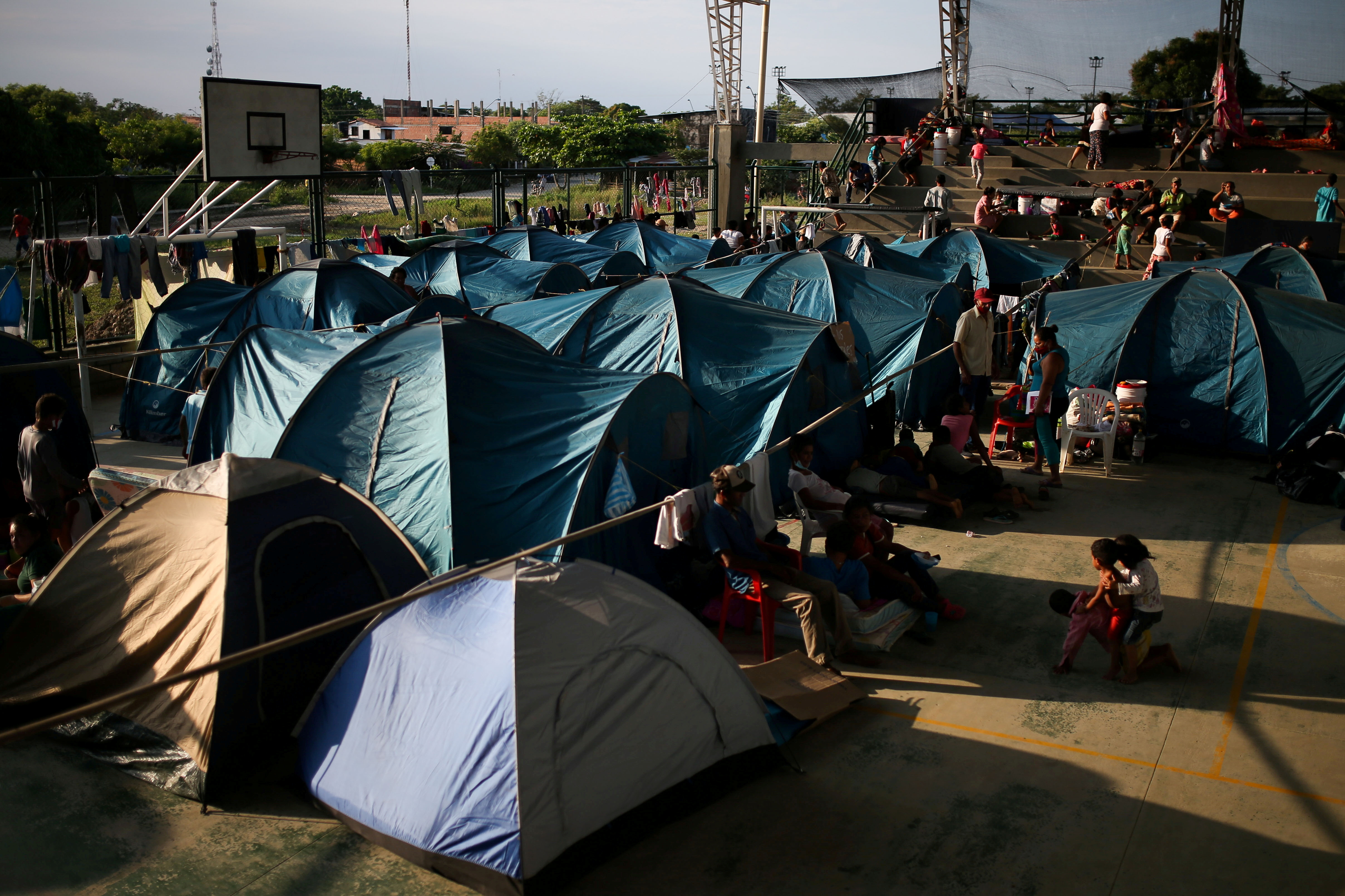Dozens of tents, erected by Venezuelan migrants, sit at a camp in a Colombian border town.